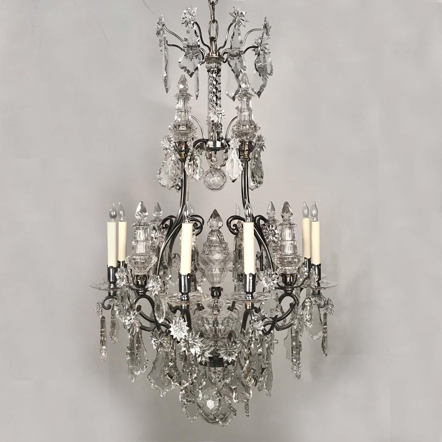 This elegant and high quality chandelier adds an atmosphere of shimmering and delicate illumination wherever it is hung. It is simply yet powerfully conceived. ....Eight-light, heavy cut spires, star shaped medallions and hefty beveled violin shaped