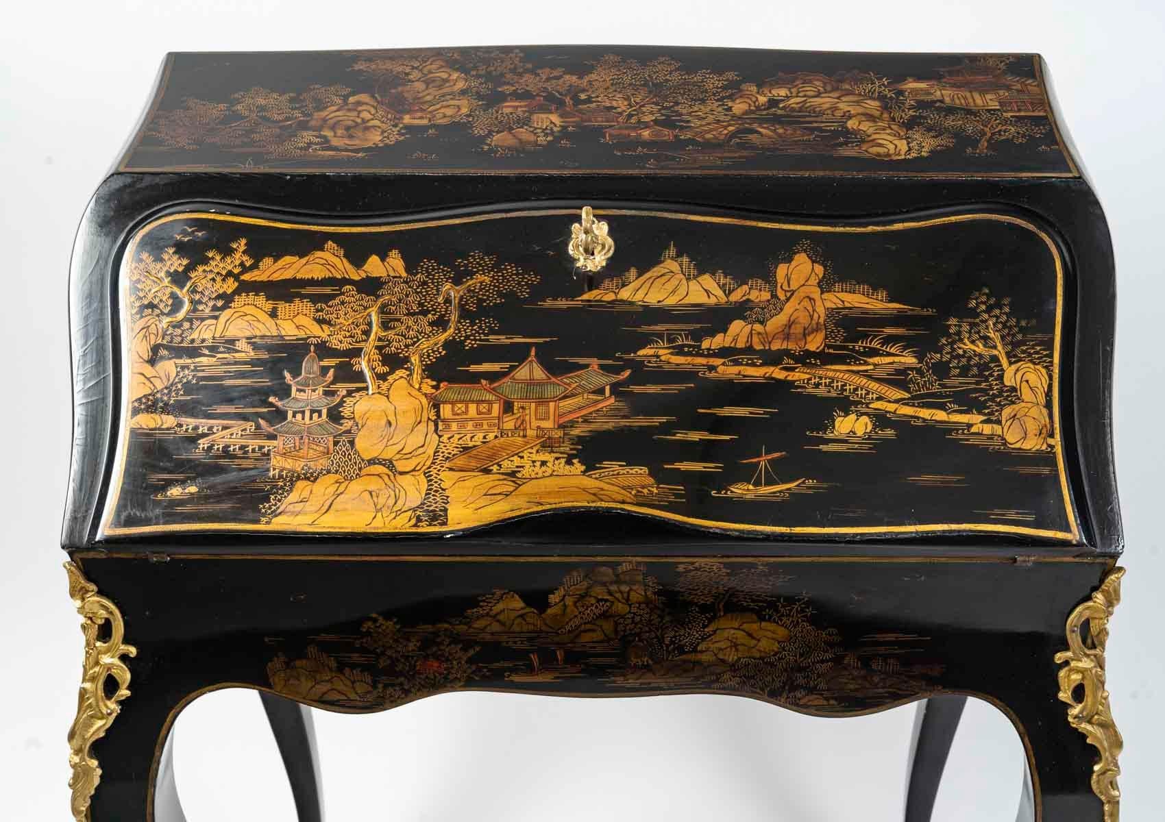 Louis XV style sloping desk in lacquer and gilt bronze.

Louis XV style sloping desk, lacquer with Chinese scene decoration, gilt bronze, early 20th century.
H: 90cm, W: 67cm, D: 40cm