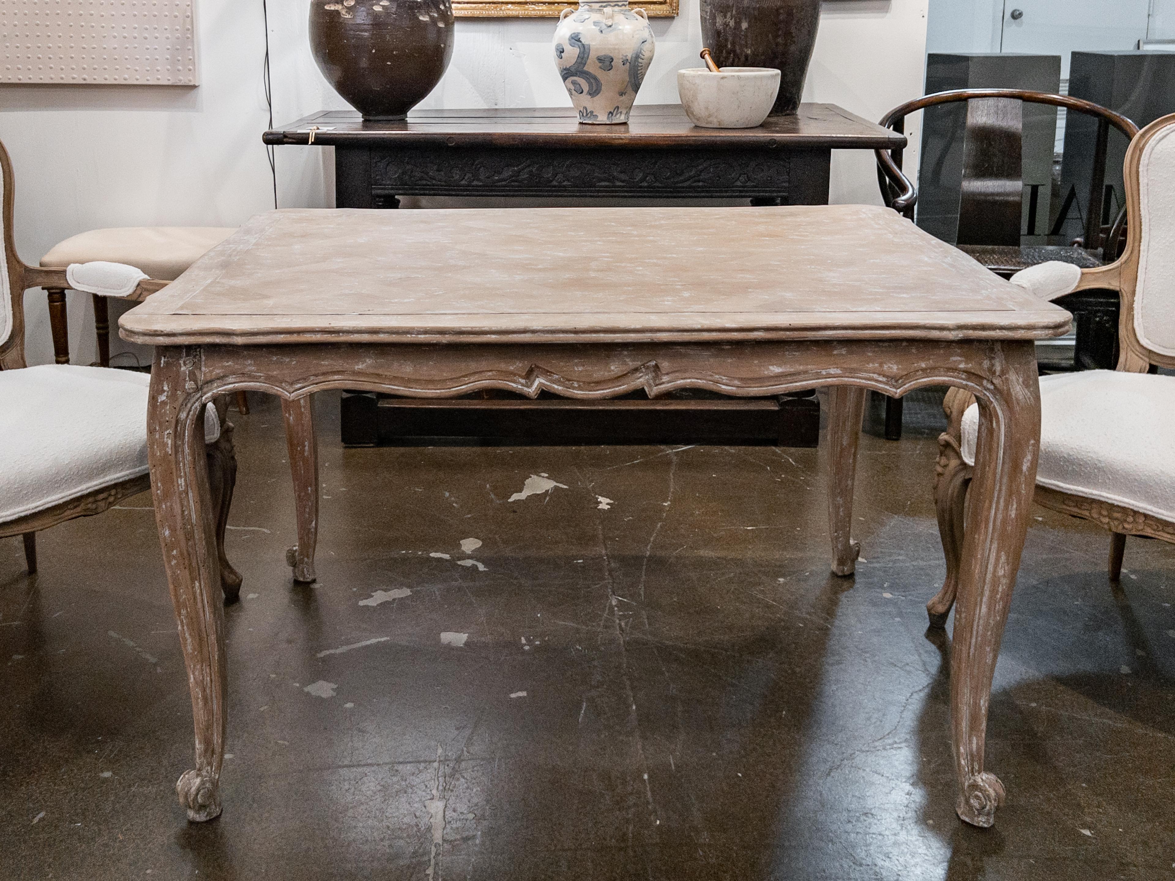 Louis XV Style Small Swedish dining table with a scraped painted finish, parquet pattern top, scalloped apron and cabriole legs.
