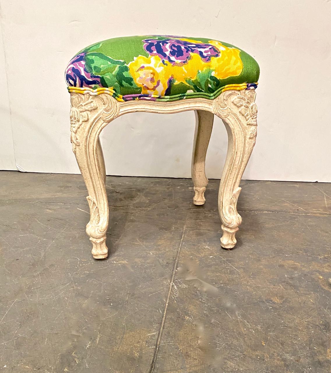 This is a beefy well-carved set of three Louis XV style tabourets/stools. The upholstery features a bold tropical patterned printed linen that bring Miami-style to mind. These three stools would make a statement placed at the end of a bed or in