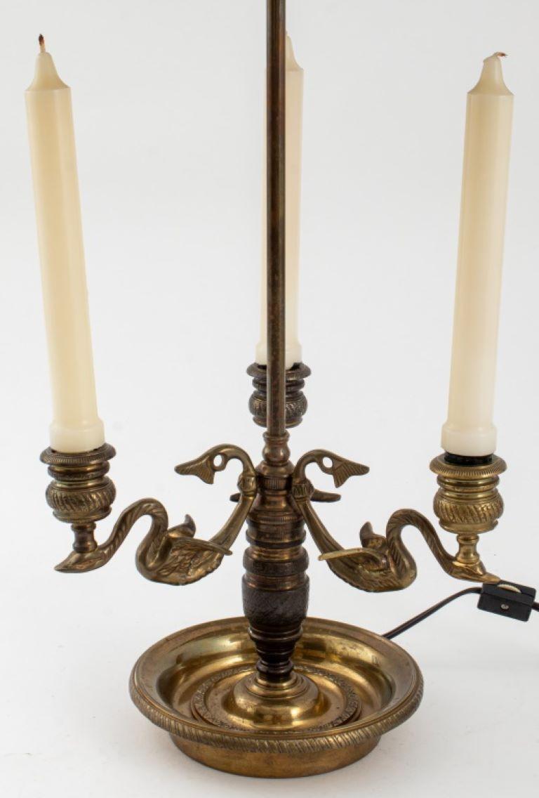 Louis XV style bouillotte lamp with three candlesticks, two light bulb fittings, a green and hand-painted gilt tole peinte shade, the gilt metal stand with swan form arms.

Dealer: S138XX