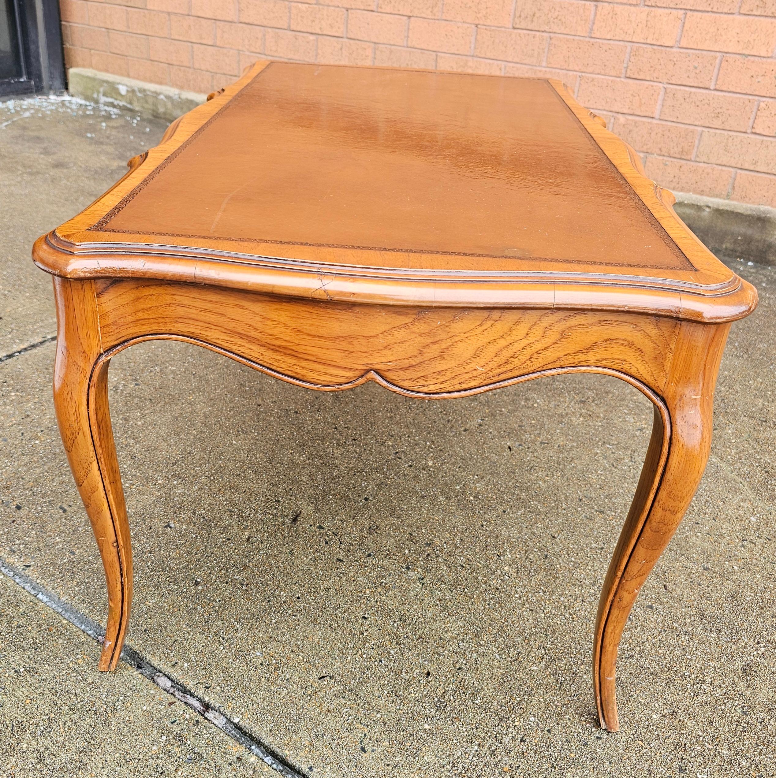 A 1942 W and J Sloane New York  Louis XV Style Tooled Leather Inset Top Walnut Coffee Table in very good vintage condition. Measures 36.5