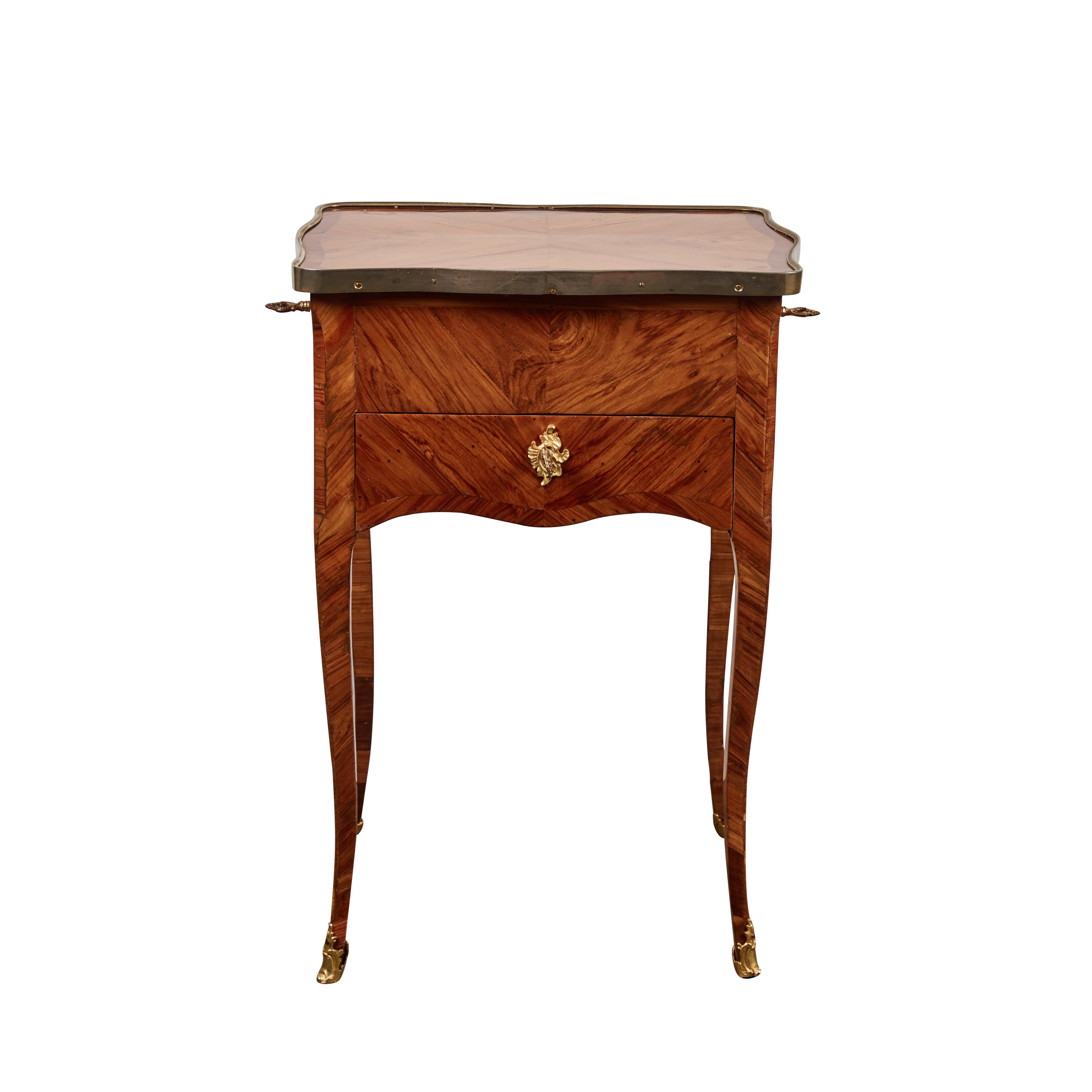 Louis XV style, 3 drawer tulipwood side table. Gilded bronze locks and sabots, 3 gilded bronze keys. Parcel gilt metal banding.