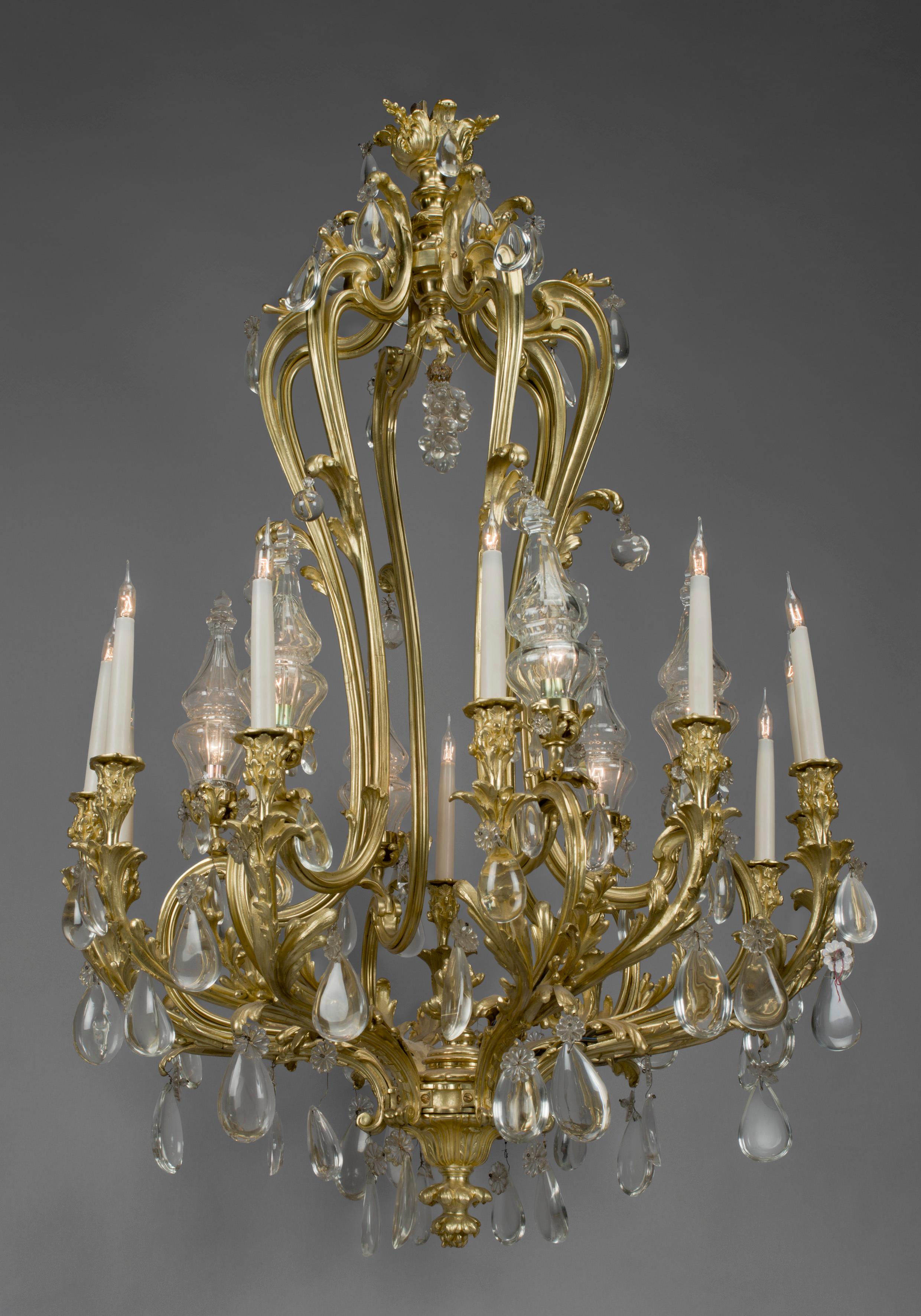 An Important Louis XV style twelve-light rock crystal and gilt-bronze chandelier.

French, circa 1850. 

An important Louis XV style twelve-light rock crystal and gilt-bronze chandelier, surmounted by a floral corona, issuing six scrolling