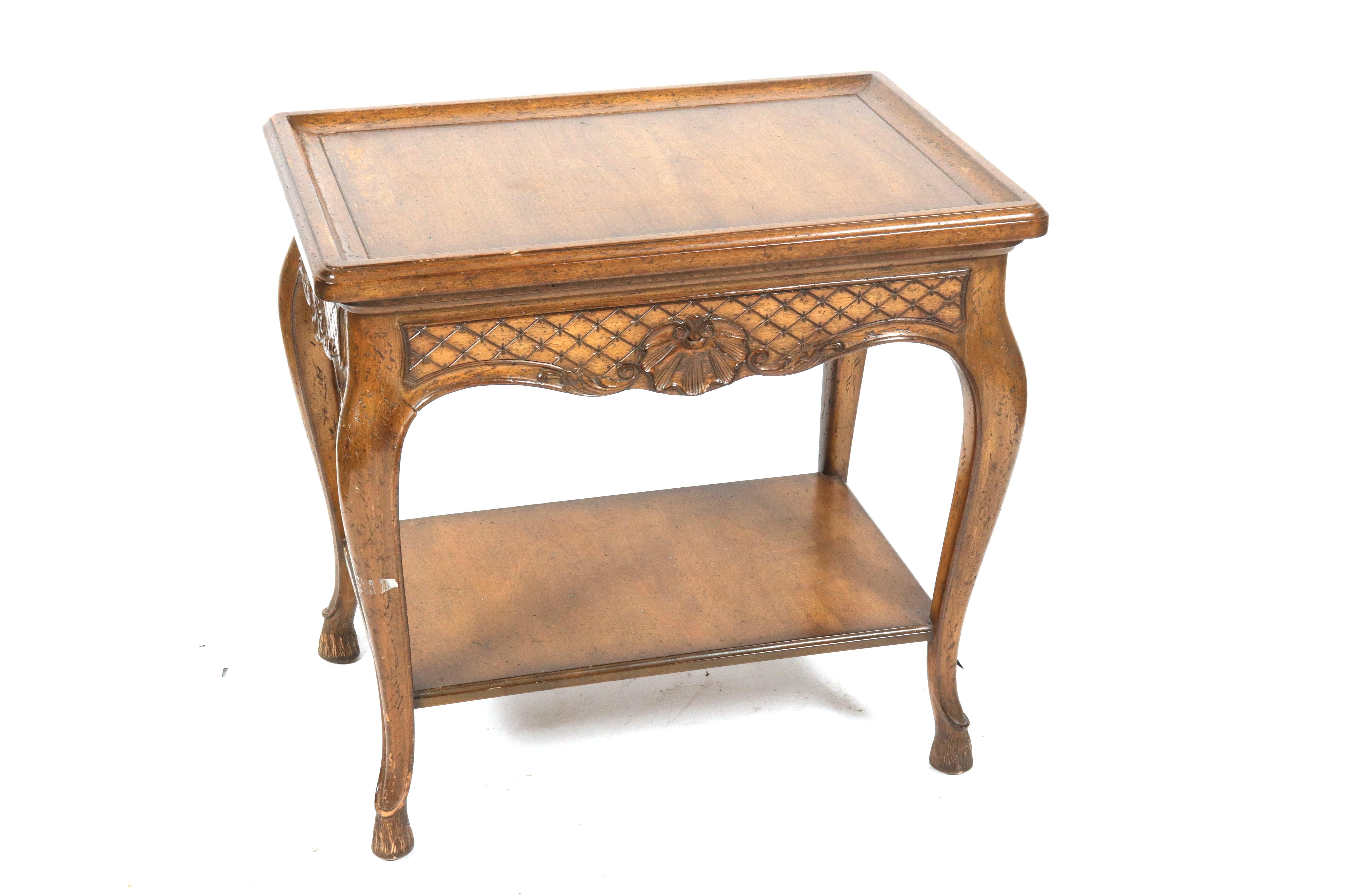 Auffray attributed Louis XV manner two-tier serving table, 20th century, with single drawer, the sides with star and lattice motif carving centered by shell motifs, all raised on stylized pieds-de-biche feet. Measures: 28.5
