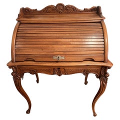 Used Louis XV style walnut roll top desk with large drawer and upper compartments.
