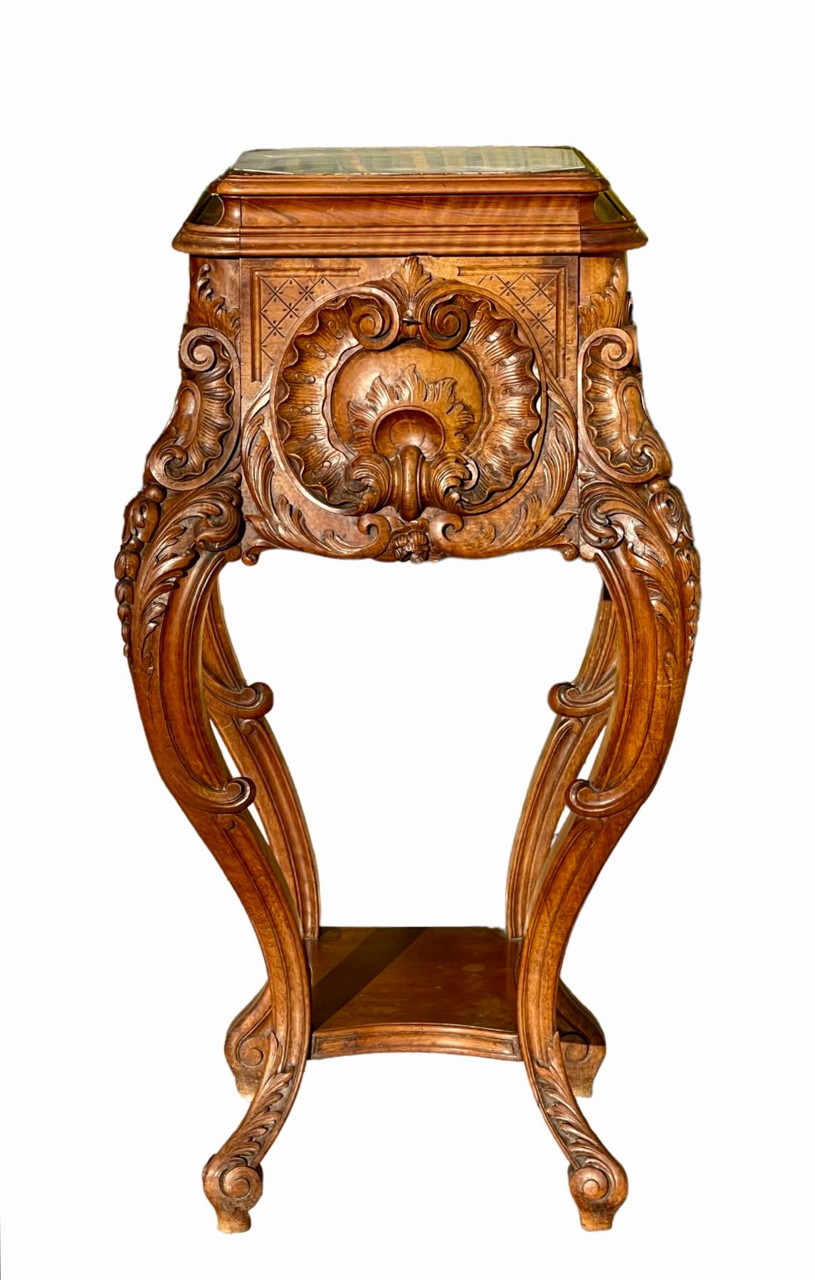 Superb carved walnut sheath in Louis XV rocaille style. White marble top, small front door with marble interior and shelf connecting the 4 legs. Very beautiful piece to present your most beautiful sculptures. French work from the 19th century of