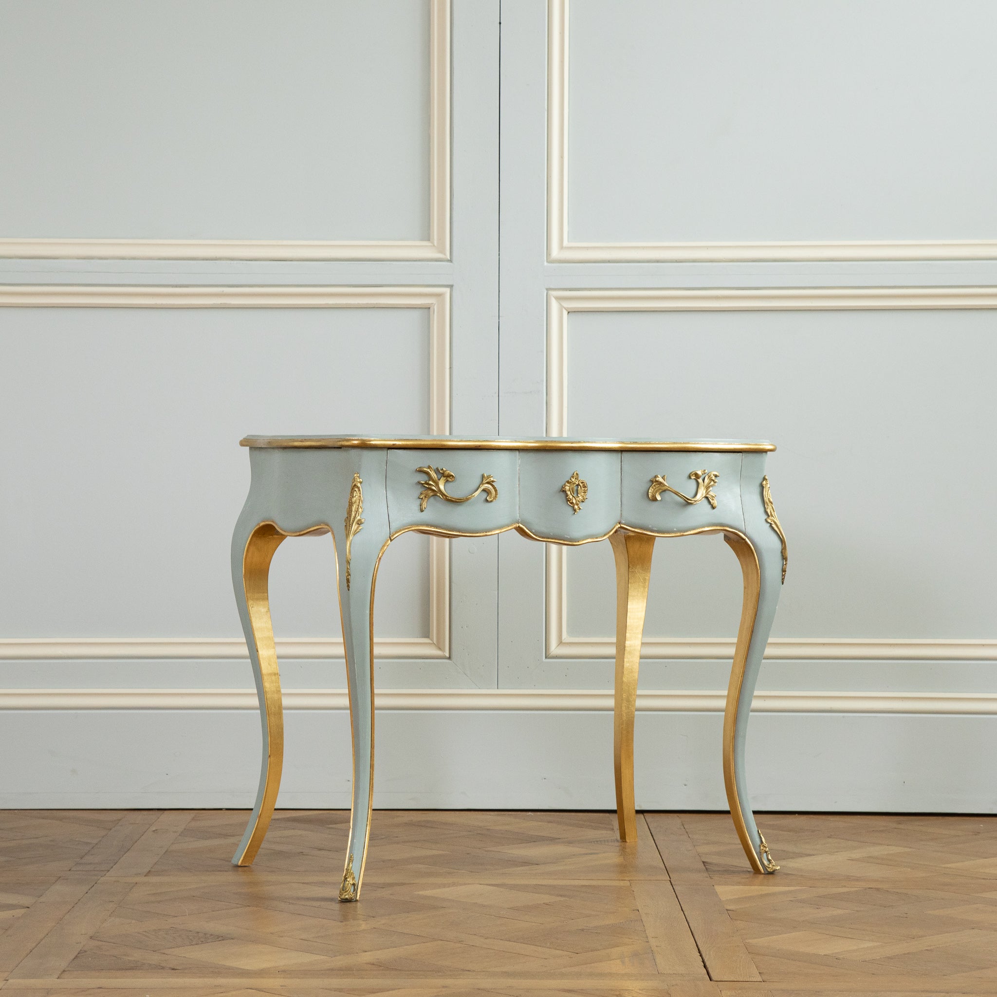 Louis XV style writing desk made by La Maison London.
Painted in a French grey with gold highlights.
mounted on Serpentine legs with decorative bronzes ornaments .
there is two drawers.
A matching stool is also available if required 
the desk