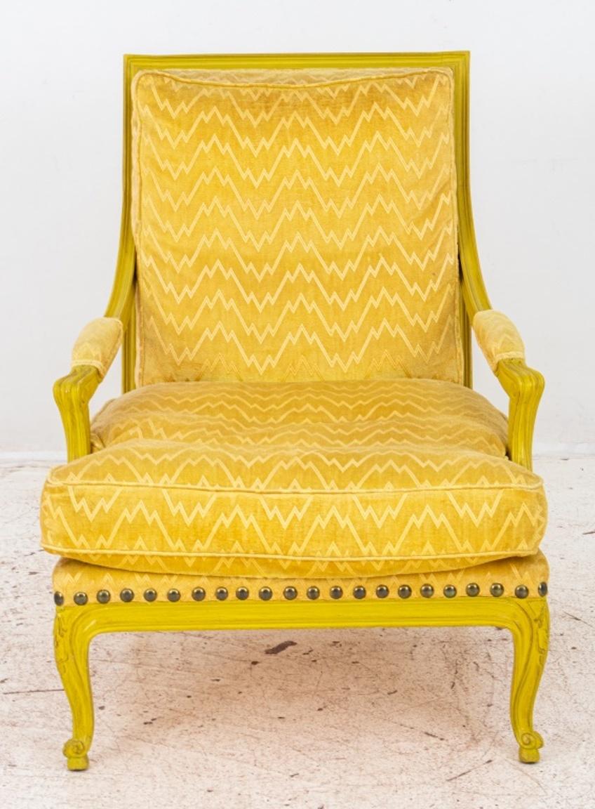 French Louis XV style yellow painted wood lounge armchair or 'chauffeuse', raised on cabriole legs with carved floral motif, upholstered in yellow fabric. In good condition. Wear consistent with age and use.

Dimensions: 35.5