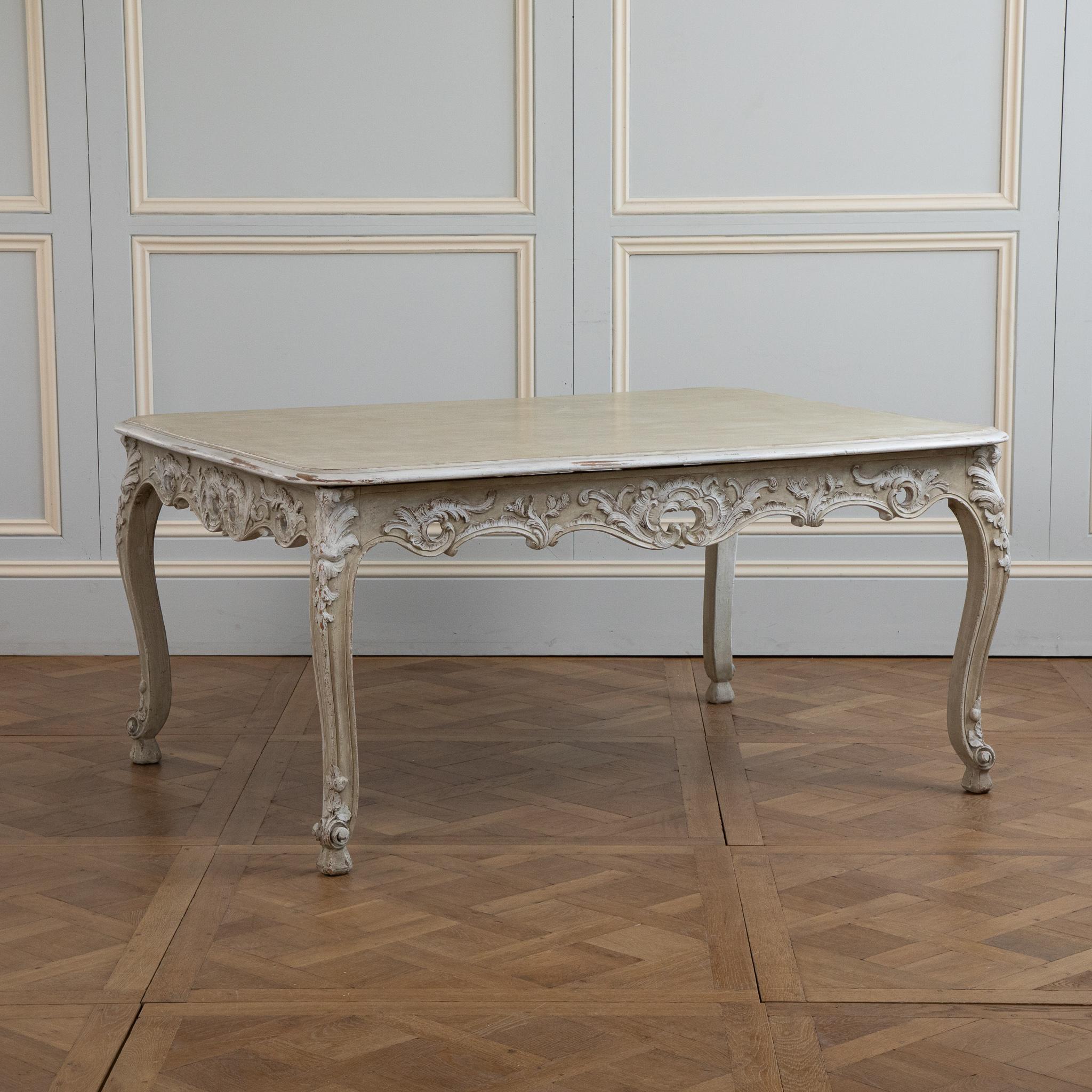 Louis XV style table in the Rococo style.
finely carved details with acanthus leafs and Louis XV Shells.
Sitting on Serpentine legs with generous Scrolled feet. 
painted in a French Sage green with white highlights
Can be used as Dinning table or