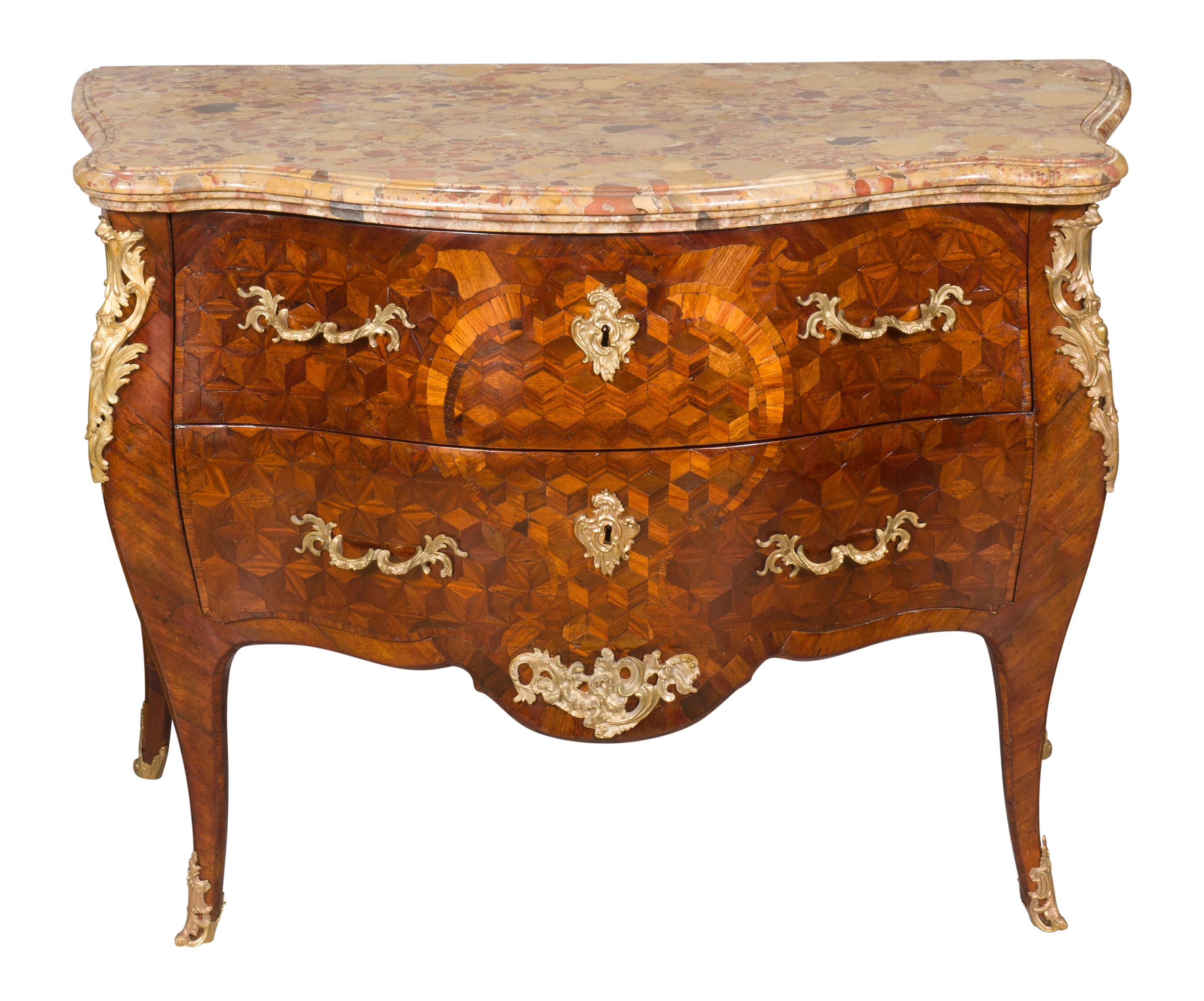 With a thick serpentine breche de alep marble top over a conforming case with two conforming drawers with bronze handles raised on cabriole legs with sabot feet. From a Bellevue Avenue Newport Rhode Island estate.
