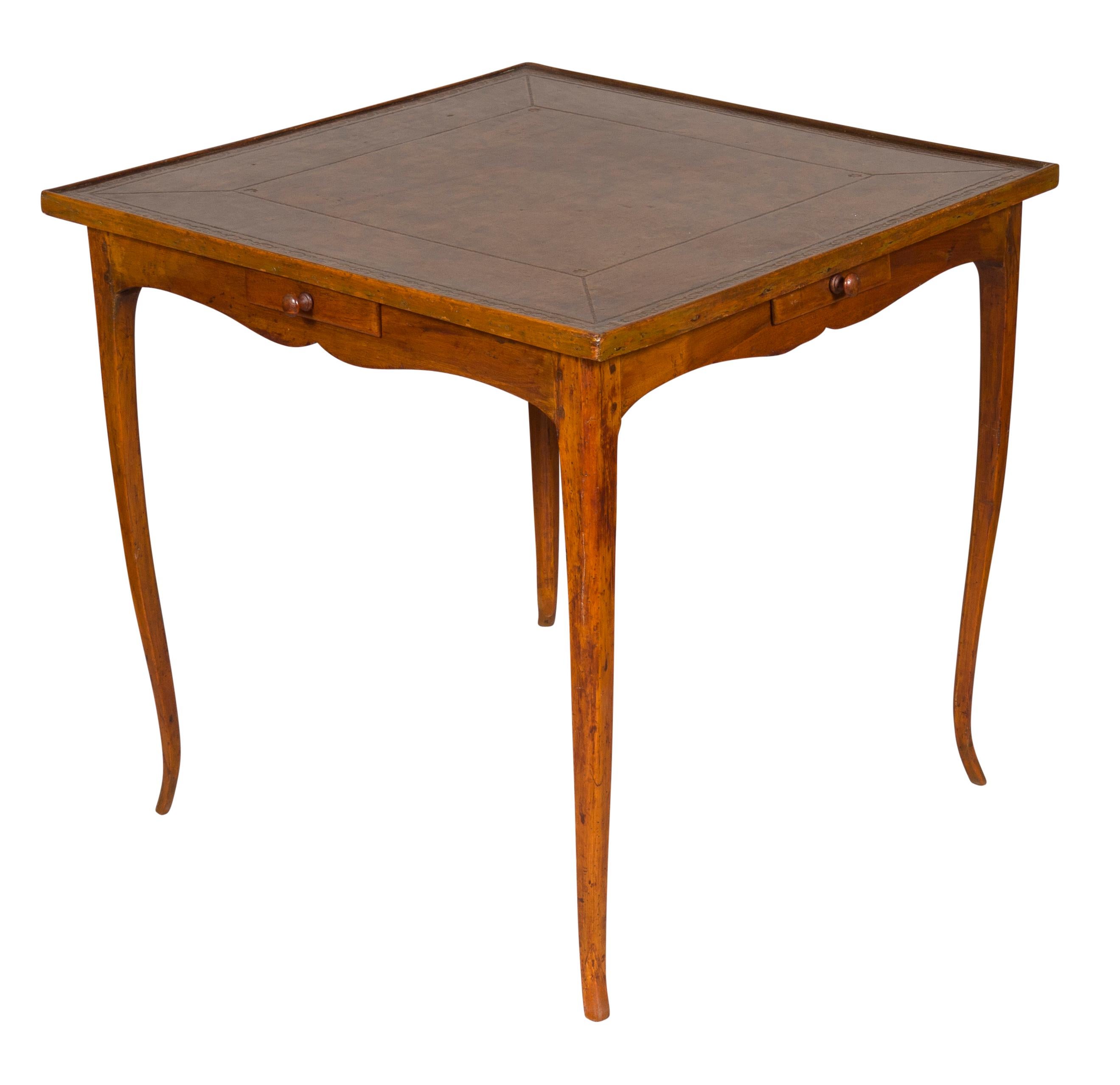 Square top with tooled brown leather over a shaped apron with four drawers, raised on cabriole legs. 
Provenance; Sophie H. Gimbel.