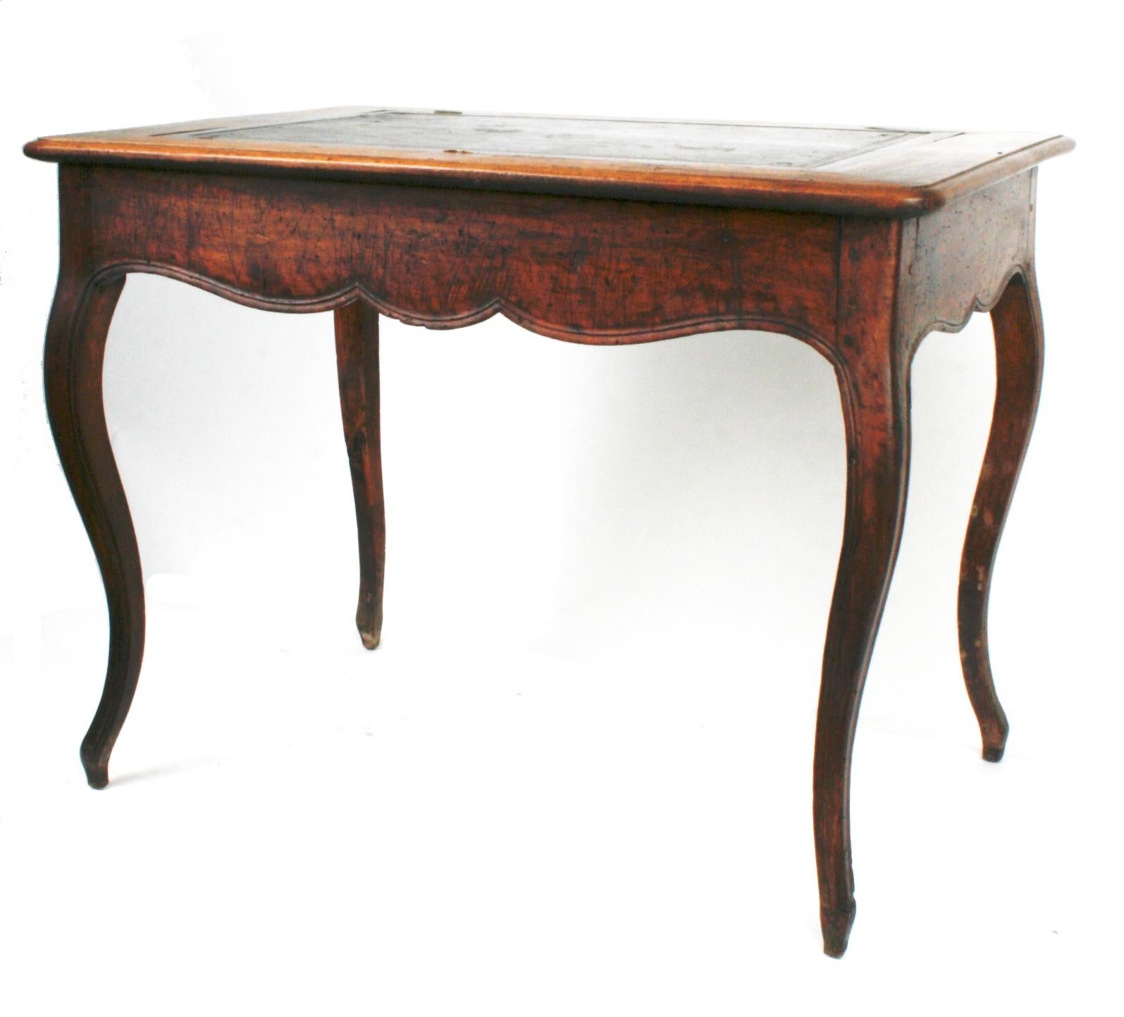 Louis XV c1770 walnut reading or writing table with adjustable leather tooled reading slope. The table has a scalloped apron with one drawer in the front and stands on cabriolet legs. The table has what appears to be an original finish and great