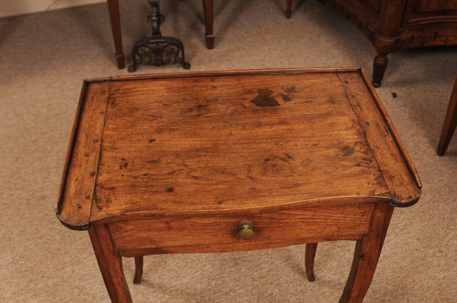 The French Louis XV walnut side table with dish top on back/ sides, 1 drawer and cabriole legs.