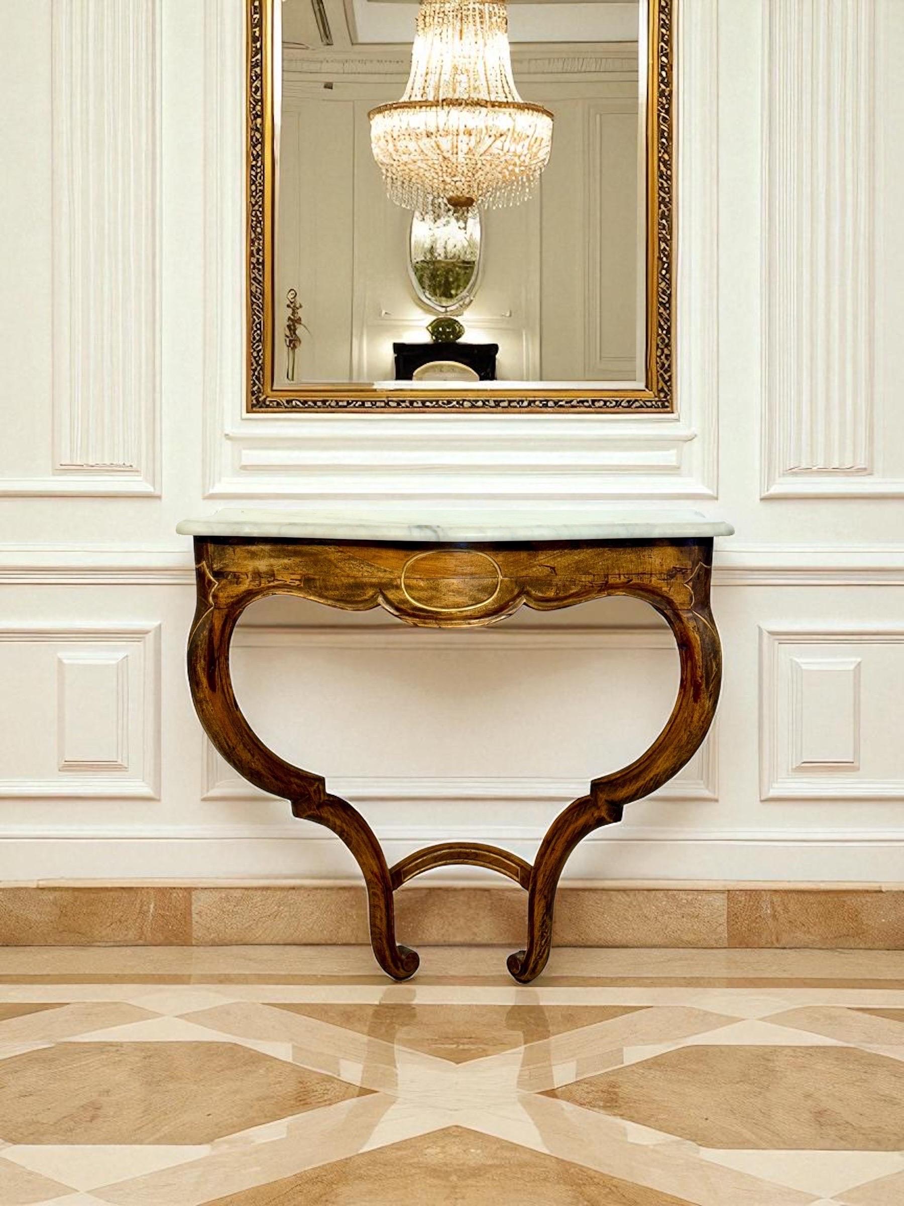 A graceful French wall-mounted console in the Louis XV revival taste, crafted in solid walnut with a warm, lively grain and a mellow patina. The shaped apron is carved with a central oval cartouche and soft scallops, flowing into paired, scrolling