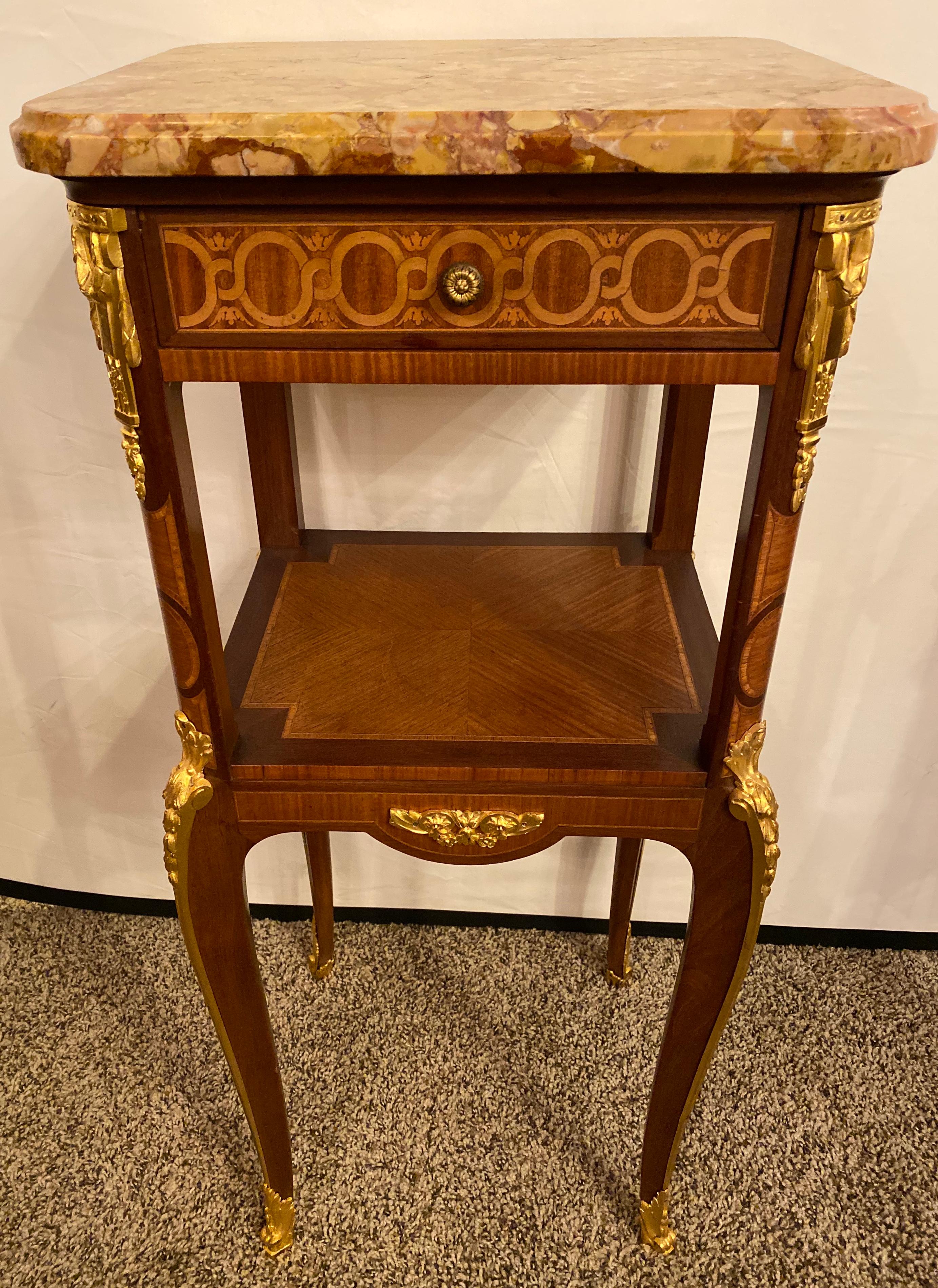 Transitional Louis XV-XVI style marble-top side table with exceptional quality bronze mounts with fine parquetry veneers. This is a stunning example of a turn of the century work of art. The marble set in place by metal pins placed into the wooden