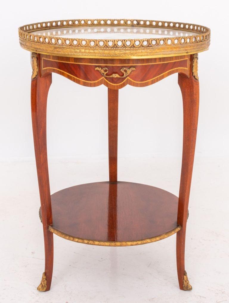 Louis XV / XVI transitional style side table or table ambulante, round with giltmetal gallery surrounding a calacatta marble top (as-is), the shaped and inlaid apron with single short drawer, with three acanthus-cast chutes on three cabriole legs