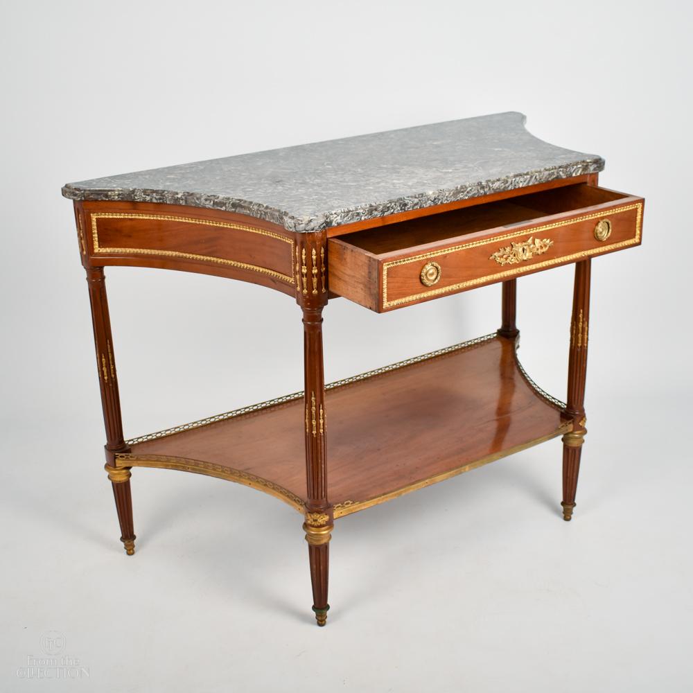 Marble topped Regency desert table circa 1820 A light mahogany ormolu mounted Empire style Regency desert table. With a single front drawer, reeded legs with ormolu mounts to them and a brass galleried lower shelf. Originally used in a dining room