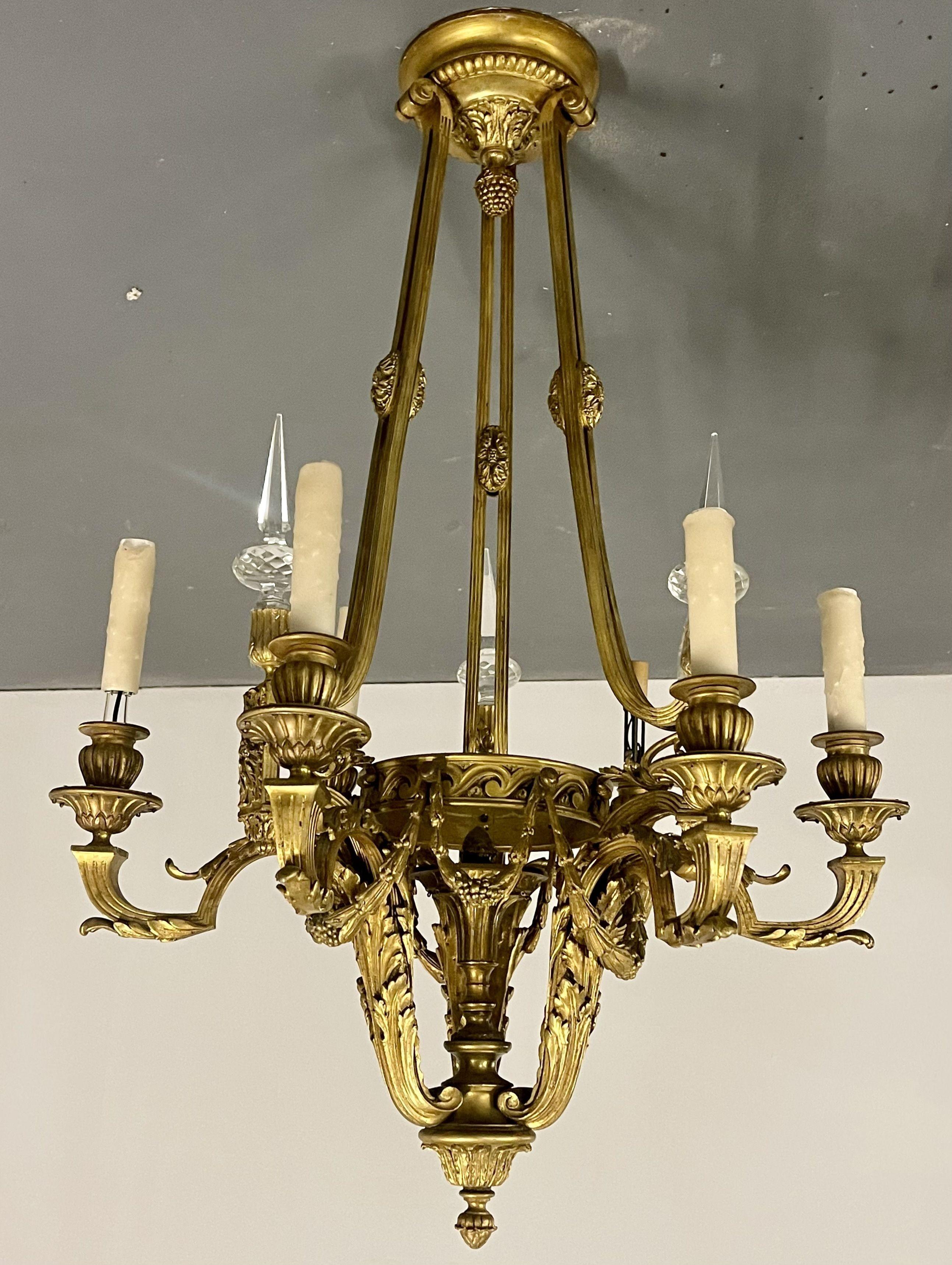 Louis XVI 19th century dore bronze chandelier, This solid bronze six light, nine arm, chandelier was recently rewired about ten years ago. Having a very fine think bronze masculine finish this seemingly flawless chandelier is certain to make a
