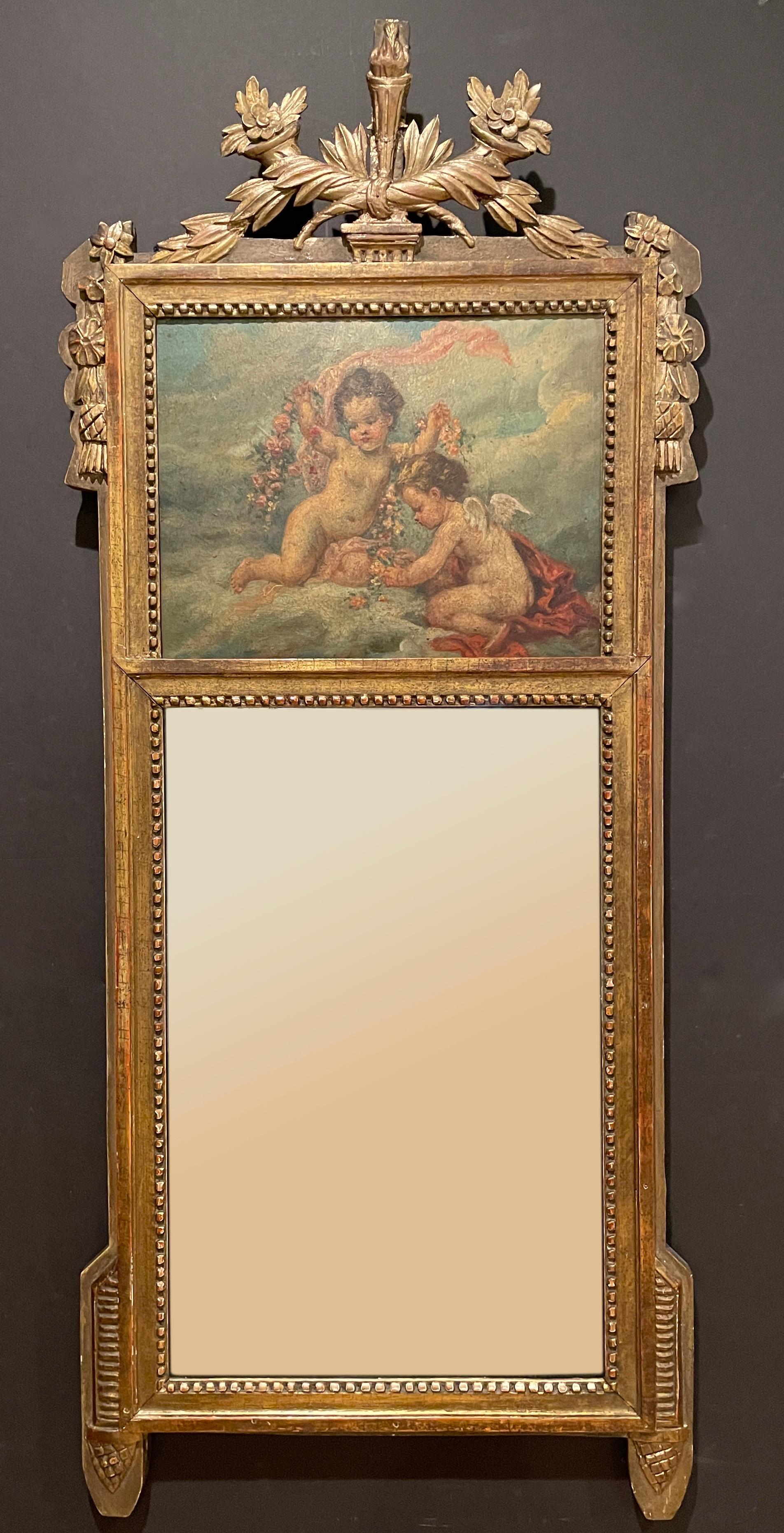 19th century trumeau mirror with fine painting of Cupids/Putti with draped flowers and fabric among the clouds. Carved wood and old gilt wood carved frame.