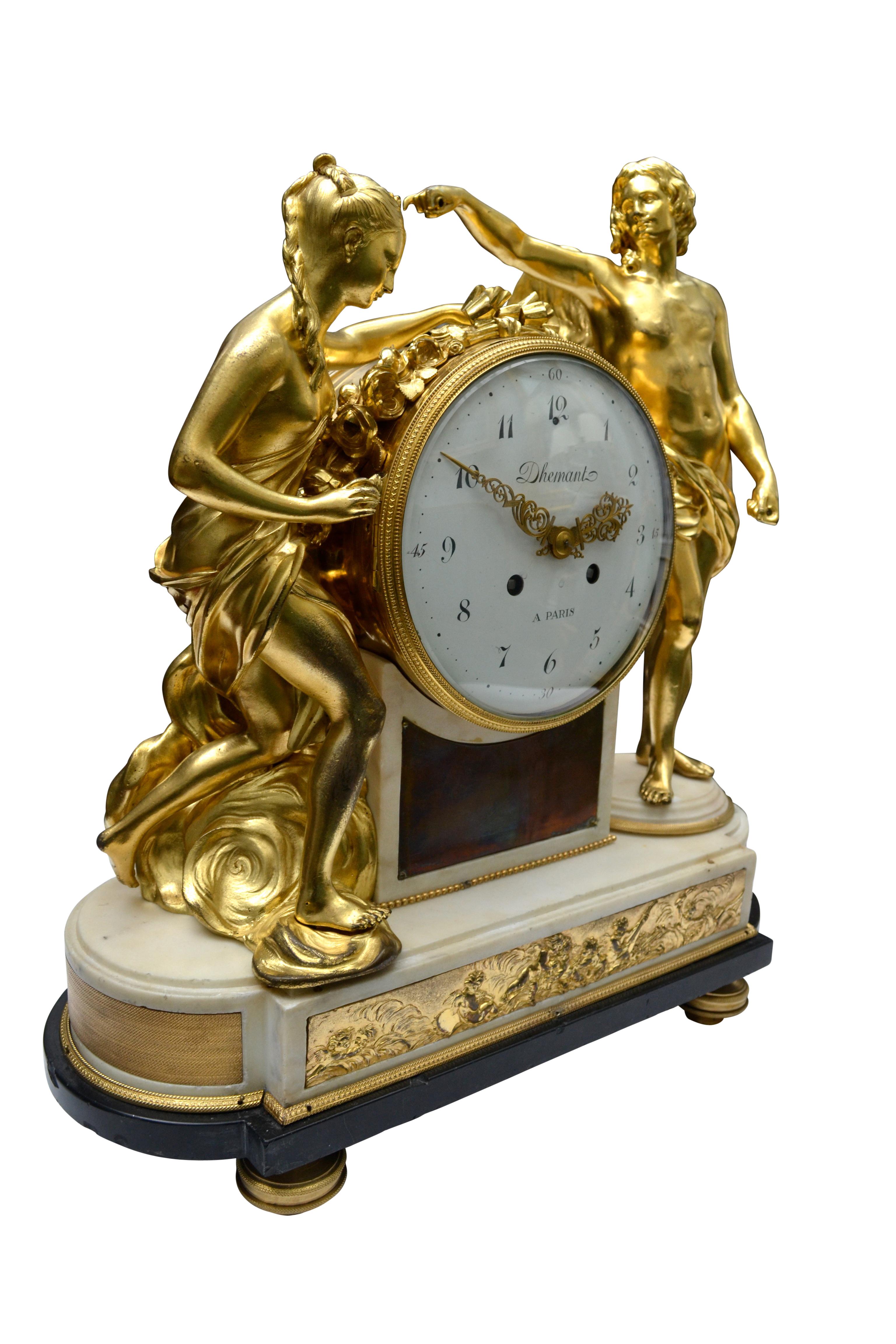 A fine and rare model of a period Louis XVI white marble and gilt bronze mantel (fireplace) clock, the dial signed Dhemant A Paris. The clock features two large gilded classically draped bronze figures standing on either side of the large white