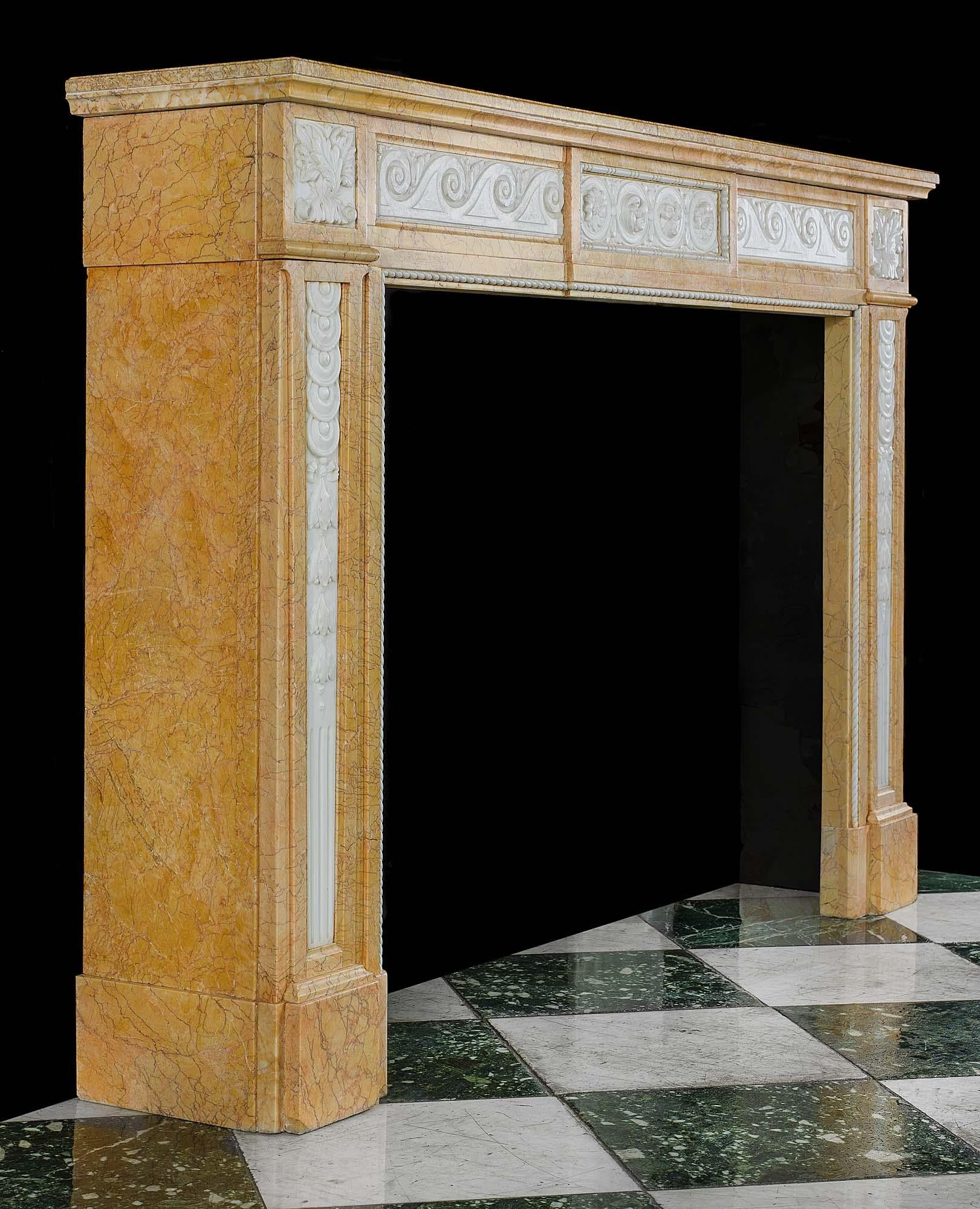 A Louis XVI style antique chimneypiece carved in Statuary and Crema Valencia marbles. The frieze, with rows of vitruvian scrolls and a central panel of stylised rosettes in a beaded frame, is flanked by square foliate endblocks above jambs with
