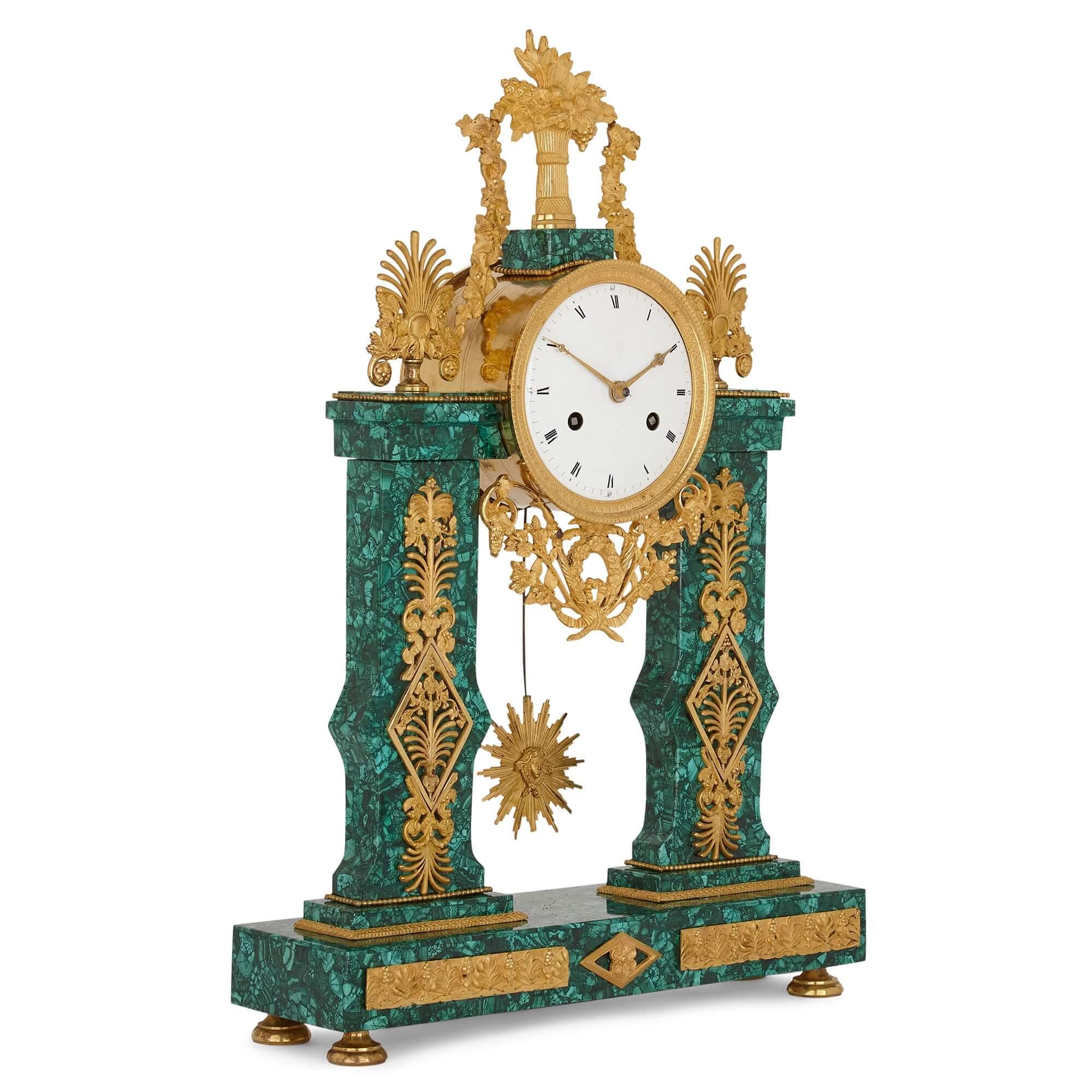 Louis XVI architectural gilt bronze and malachite clock
French, late 18th century
Measures: Height 53cm, width 35.5cm, depth 11cm

Crafted from ormolu and a later malachite veneer, this refined Louis XVI period mantel clock is designed in a