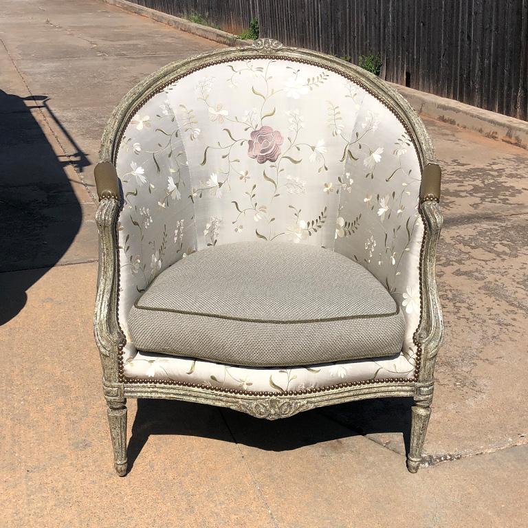 Louis XVI Barrelback Bergere embroidered silk armchair by Minton-Spidell.

French painted and decorated Bergere chair by Minton Spidell. Down seat cushion with finely carved details. 18th-century French style design. A gorgeous piece like new by