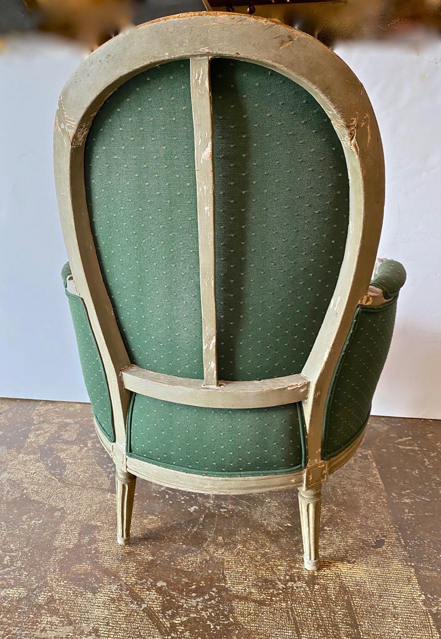 This a good example of the iconic Louis XVI bergère. The oak frame appears to retain it's original painted surface with very minor touchups. The quality of the carving, the doweled construction and the presence of square nail holes are the hallmarks