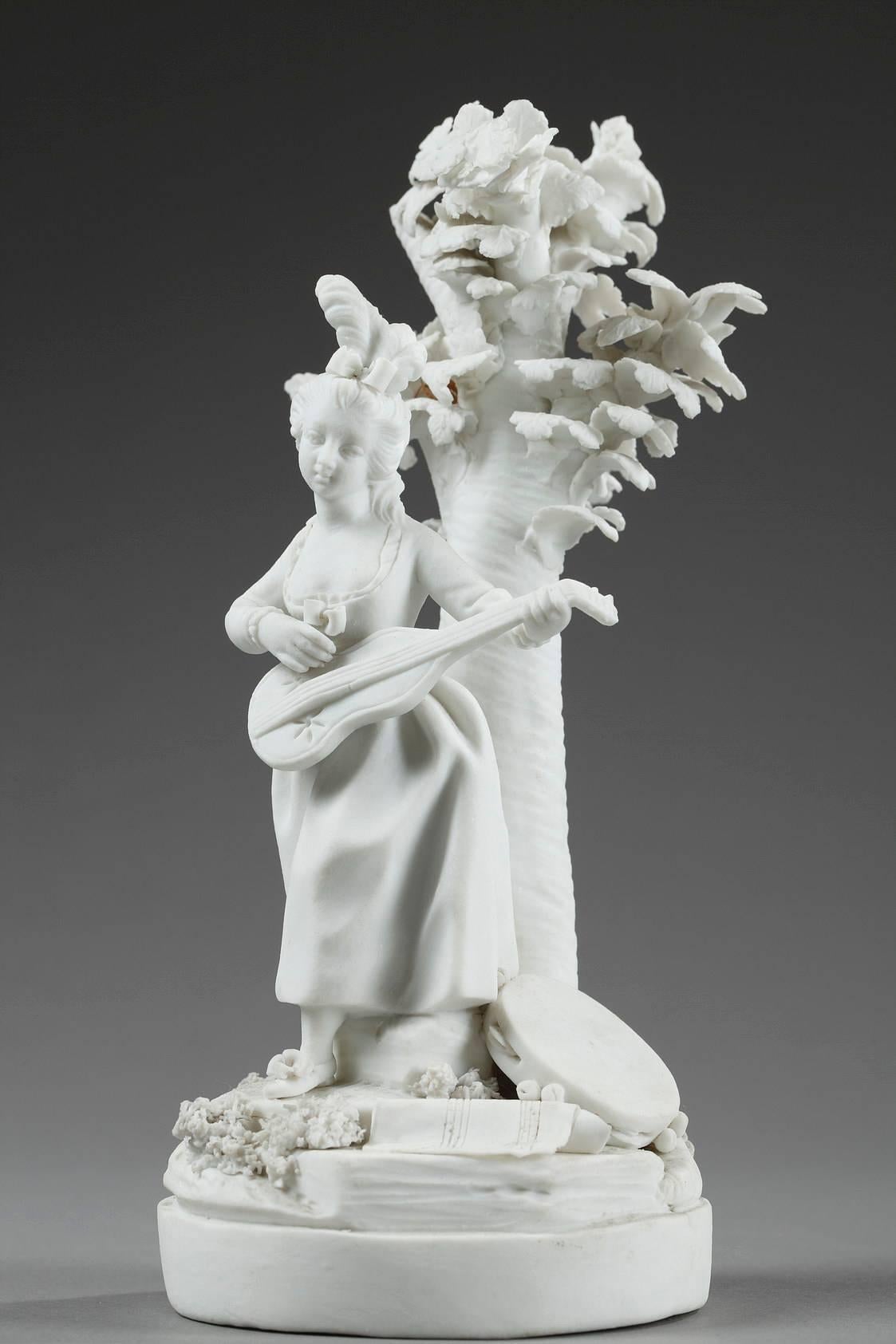 Late 18th century pair of bisque figurines. The set is very intricately sculpted, depicting two musicians holding instruments and leaning against trees with instruments at their feet. Marked underside: two crossed, flaming torches and W. Locre and