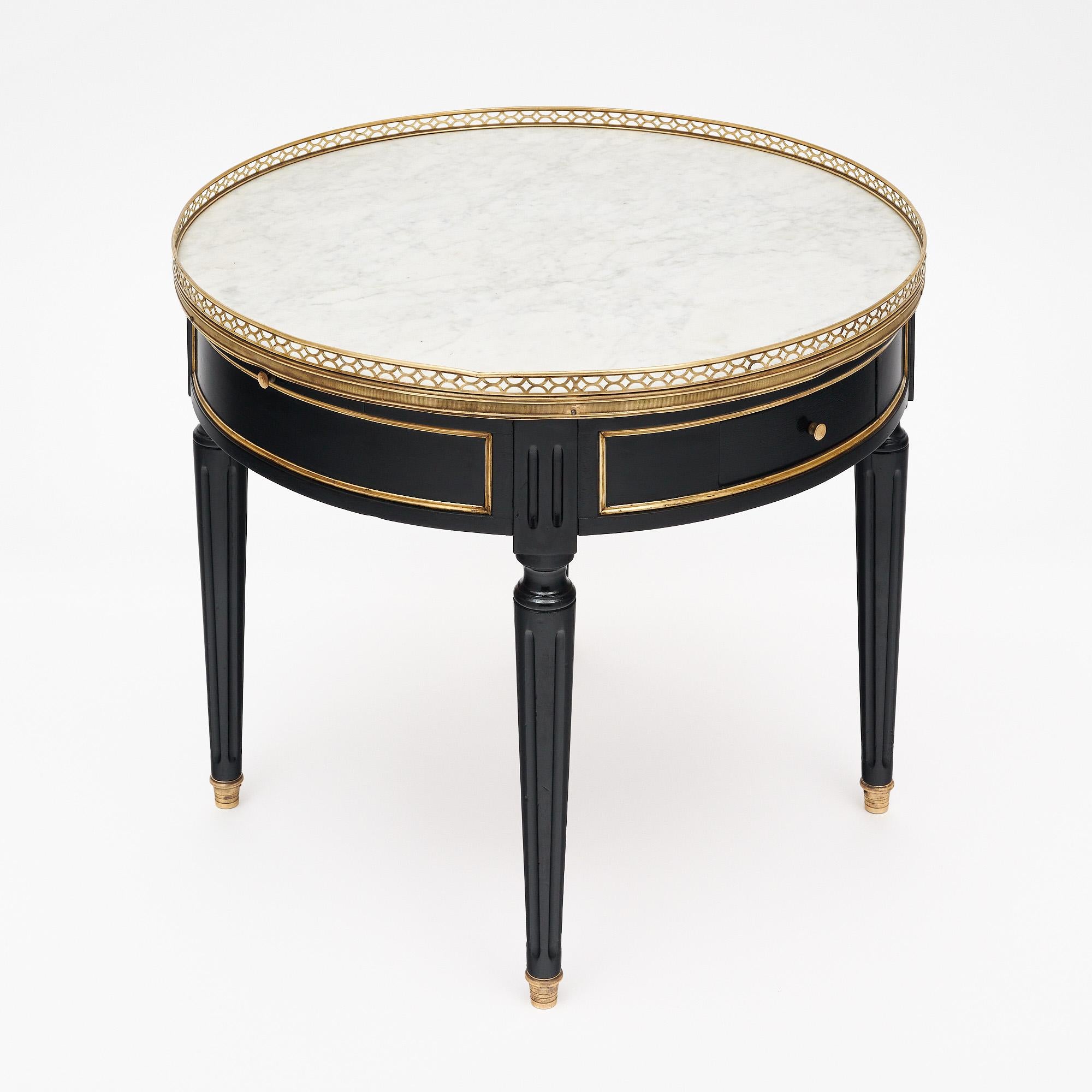 Side table from France in the Louis XVI style. This charming side table table is made of solid wood construction, primarily mahogany. It has been ebonized and finished with a lustrous French polish of museum quality. The four tapered legs are fluted