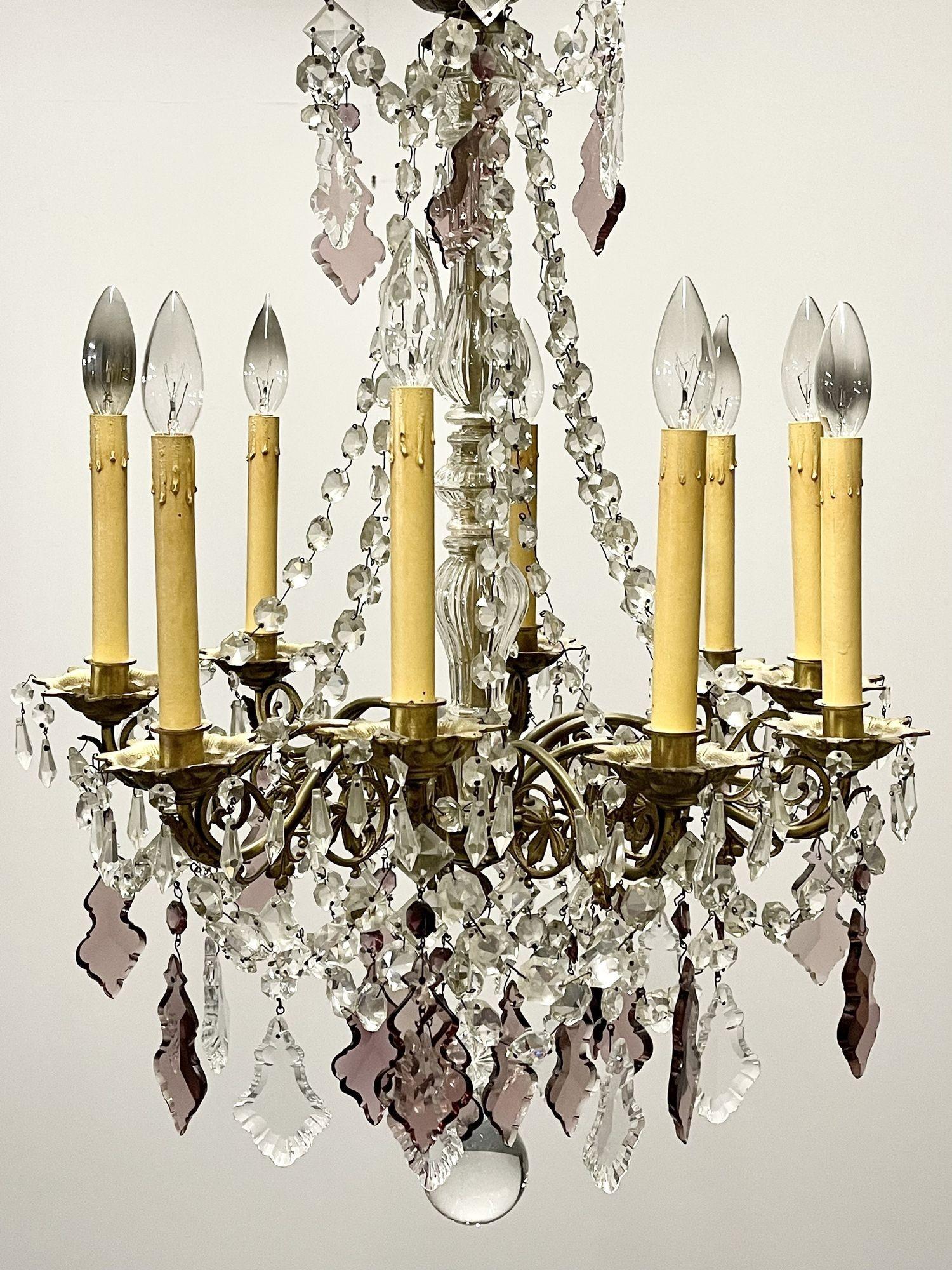 A stunning French dore bronze chandelier of Louis XVI Style having 9 lights. The finely chased bronze having colored and clear crystals dated to the late 19th century. The center column form flanked by drapery crystals form a small ballroom look. 
