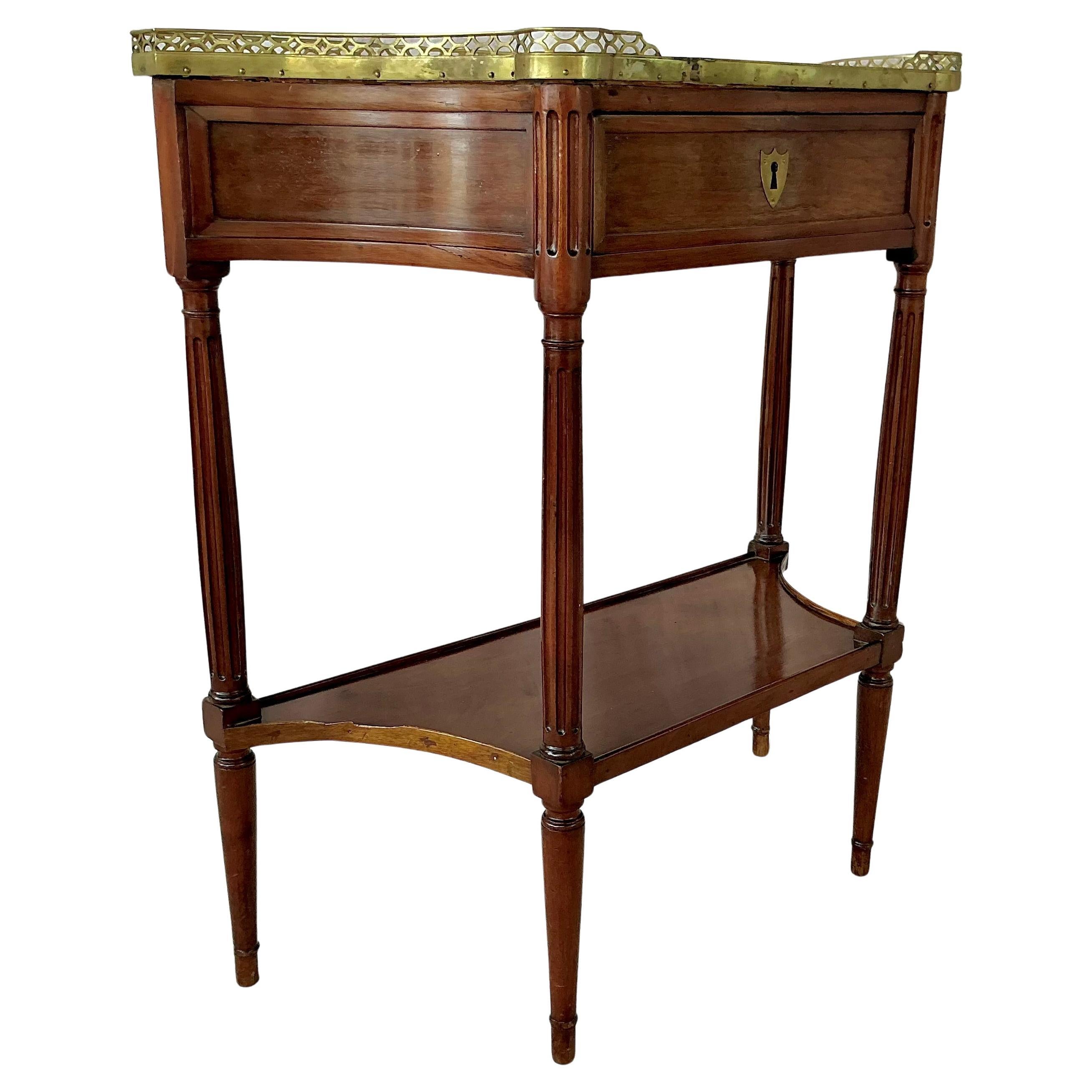 Louis XVI Period French Console Dessert Server. Server features richly solid Mahogany and refined with gilt bronze mounts throughout. The piece is topped with a shaped marble surface, beautifully framed by a pierced bronze gallery. Below, a single