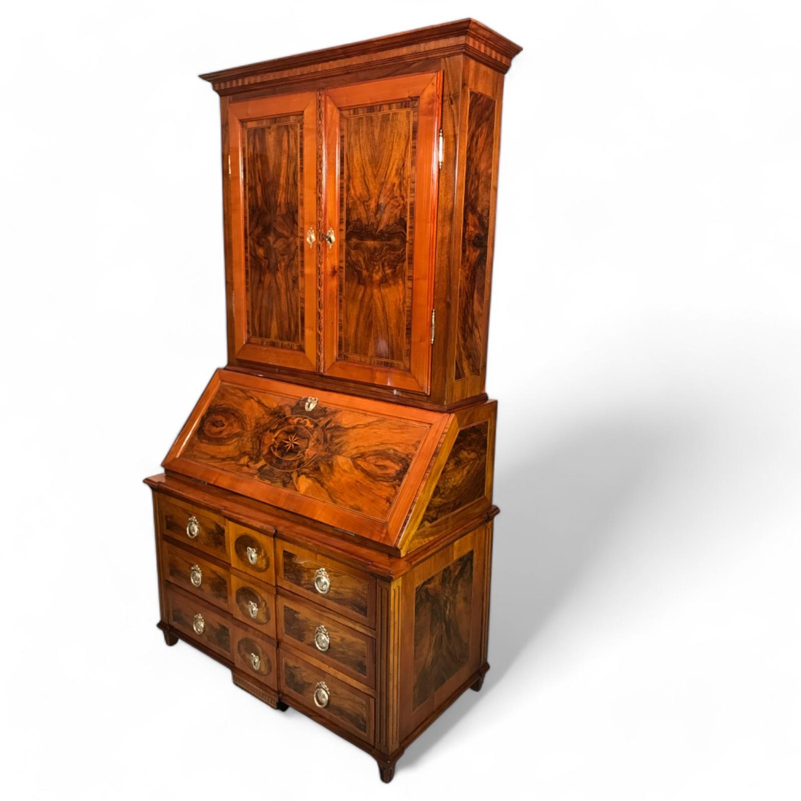 Exquisite Louis XVI Secretary Cabinet, South Germany, 1780

This remarkable Louis XVI Secretary Cabinet, crafted in South Germany around 1780, showcases a sophisticated blend of walnut, walnut root, and cherry veneer, enhanced with intricate
