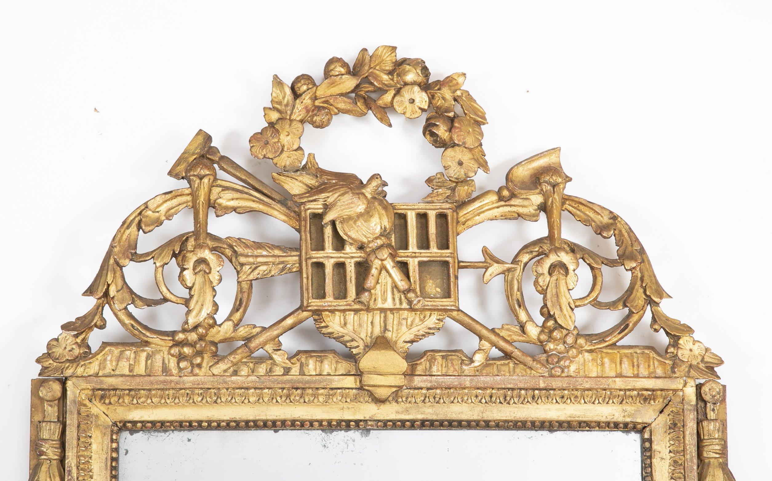 French Louis XVI carved giltwood courting mirror with carved birds and flowers, and bellflowers.
     