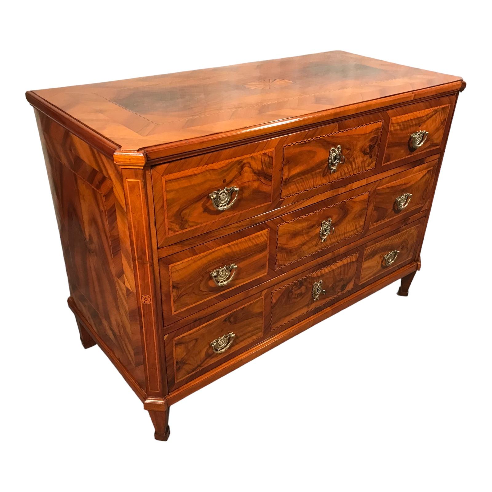 Elevate your living space with our exquisite Louis XVI Chest of Drawers, a masterpiece from 1780 originating in Germany. Crafted with precision and adorned with the finest walnut veneer and marquetry decor, this antique beauty is a testament to the