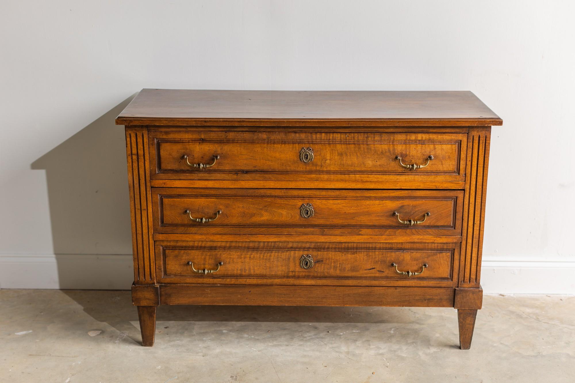 It doesn't get more classic than this Louis XVI chest of drawers. The wood species is unknown for this piece, but the dark stain gives this chest such a smooth and warm feel. There are 3 drawers with original drawer pulls and hardware.