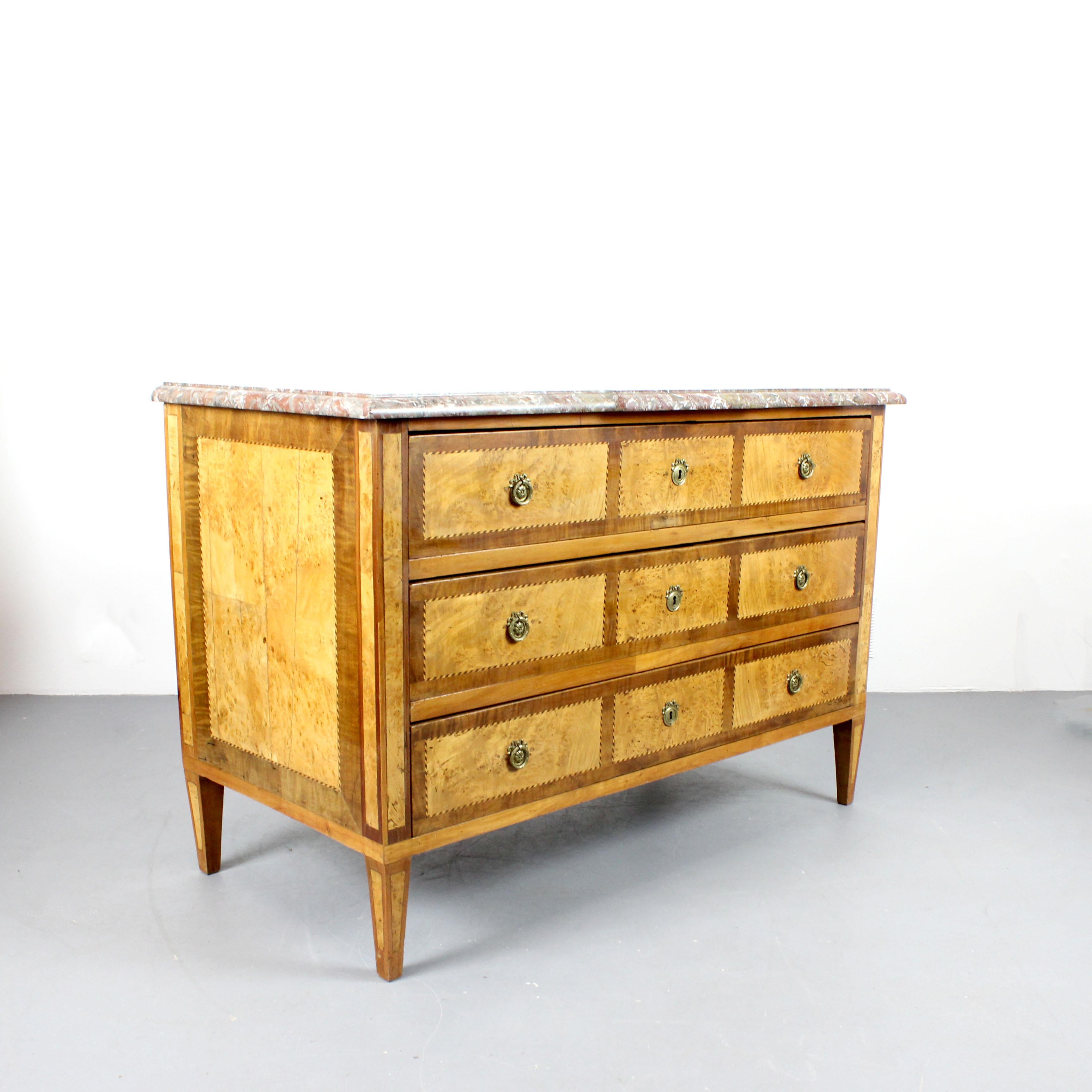 This Louis XVI-style dresser boasts a veneered wood structure, a striking veined marble top, and decorative gilded bronze handles.  It's a beautiful piece of French furniture from the early 18th and 19th centuries.
