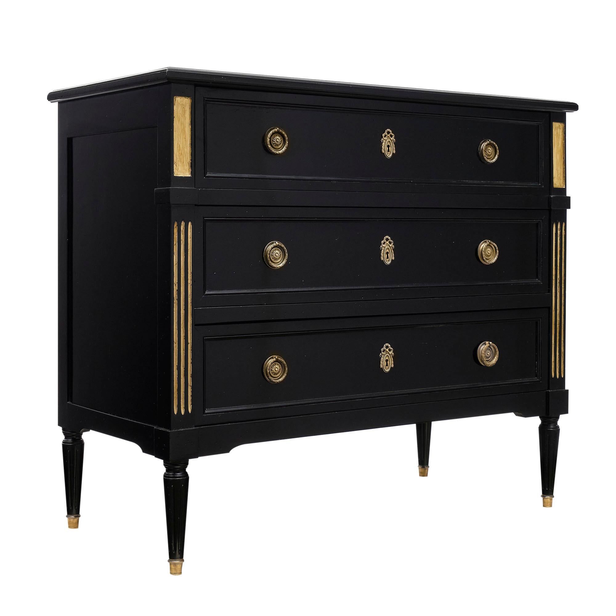 Louis XVI chest / secrétiare from France made of solid cherrywood that has been ebonized and finished in a lustrous French polish. The gilt brass hardware and gold leafed fluting adds beautiful detail. Above the two bottom dovetailed drawers is a