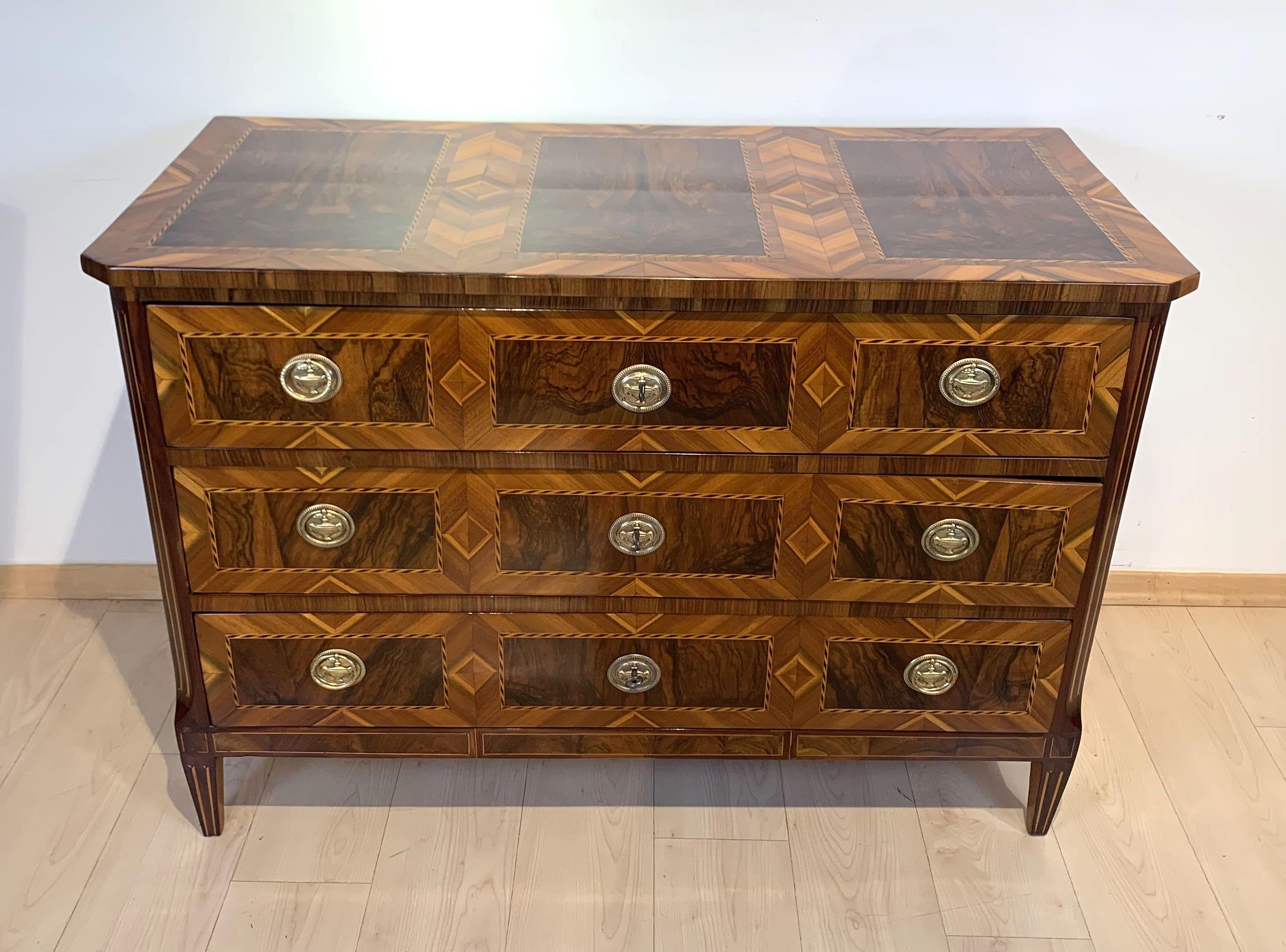 Beautiful and very elegant original, greatly restored Louis XVI. / Louis seize commode / chest of three drawers from Munich, South Germany circa 1790.

Perfect walnut veneered on pine with inlays in maple, plum and ebony. Three drawers with big