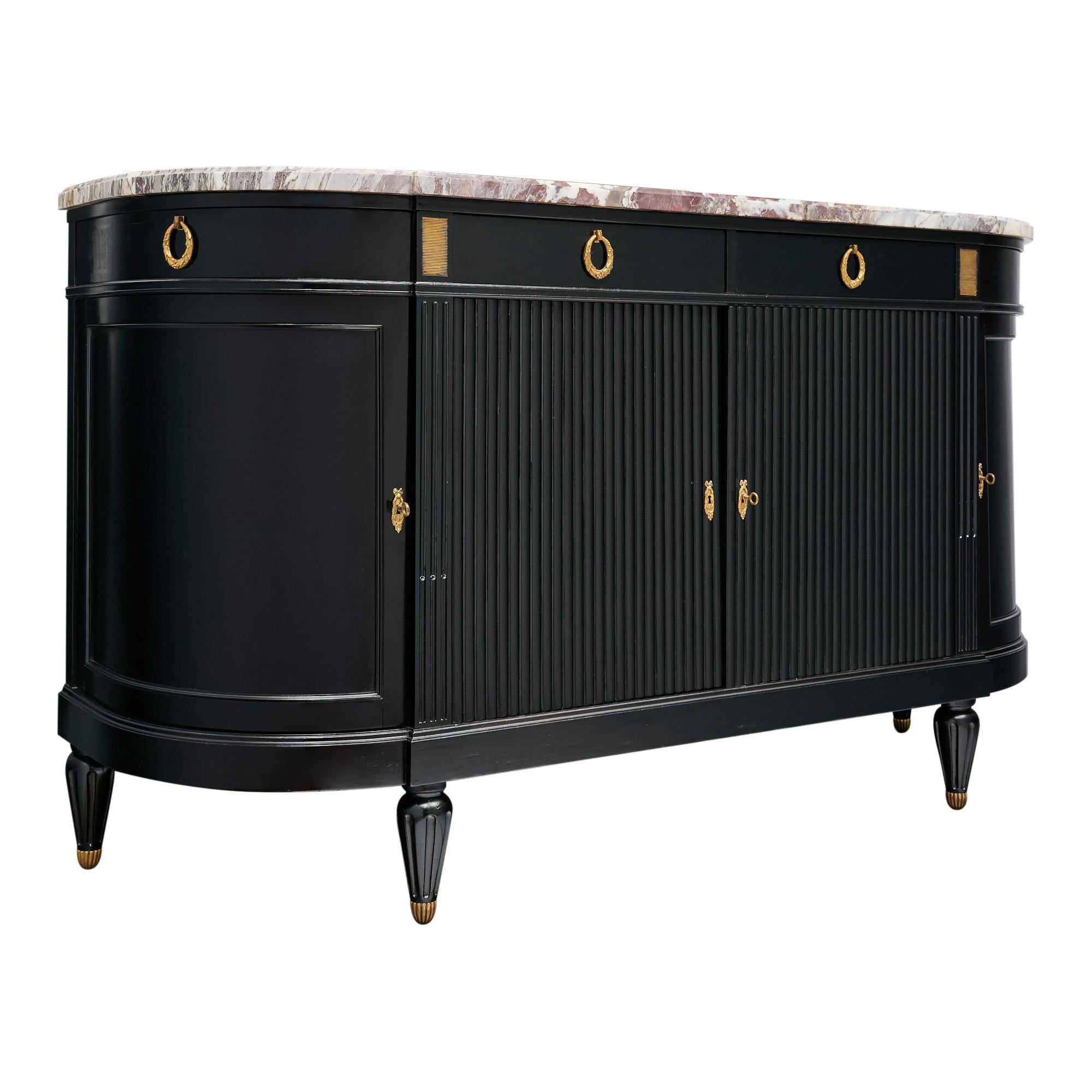 Buffet from France in the Louis XVI style. This piece is made of solid wood construction; primarily mahogany. It has been fully ebonized and finished with a lustrous French polish. There are four doors that open to interior shelving; including two