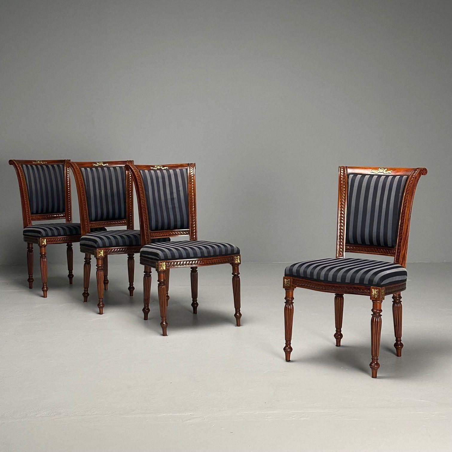 Louis XVI, Dining or Side Chairs, Walnut, Navy Fabric, Giltwood, United States, 2000s

Set of four dining chairs in the Louis XVI style with walnut frames, navy blue striped fabric, and giltwood floral accents. The chairs sit on reeded and tapered