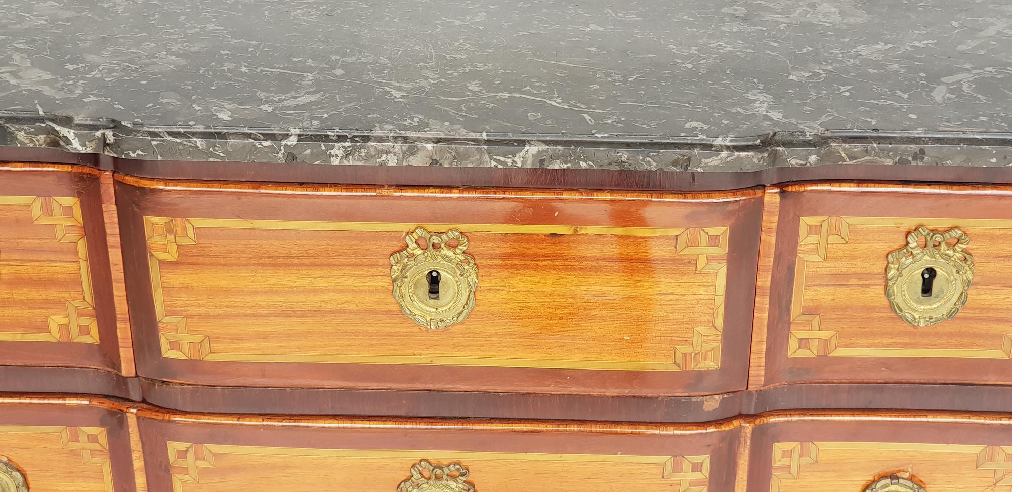 Louis XVI dresser, attributed to Pierre Defriche, 1790s. Made of walnut and other Fine woods. 

Feet flared with gilded pawfoot sabots. Round chamfered sides with marquetry cannelurs. Profiled furniture body. Frame with apron, on the apron there