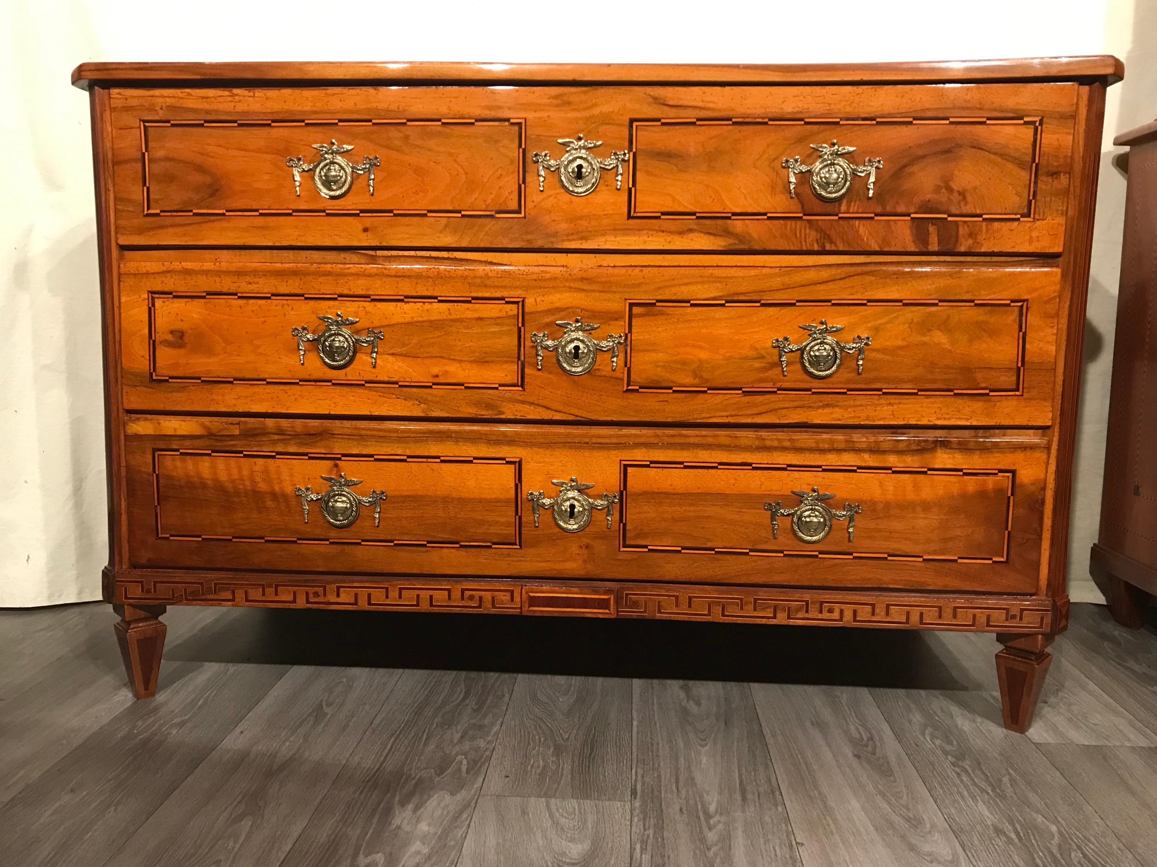 Louis XVI dresser, South Germany 1780,
Walnut massif with geometric intarsia in plum on front, top, base and the sides. This very pretty Neoclassical chest of drawers is in very good refinished condition. The sleek design is easily combinable with