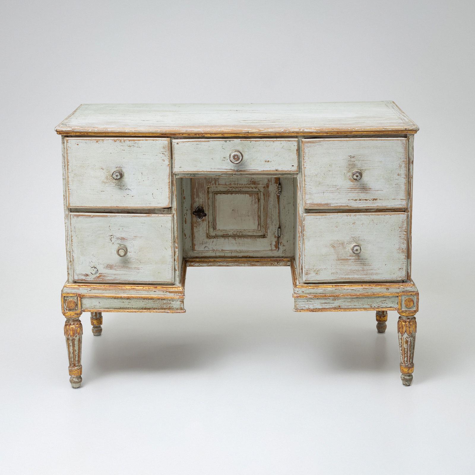 An elegant Louis XVI-style dressing or writing table, crafted circa 1780. The table is newly finished in a delicate light blue with an antique patina, giving it an authentic historical character. It features five drawers and a single-door
