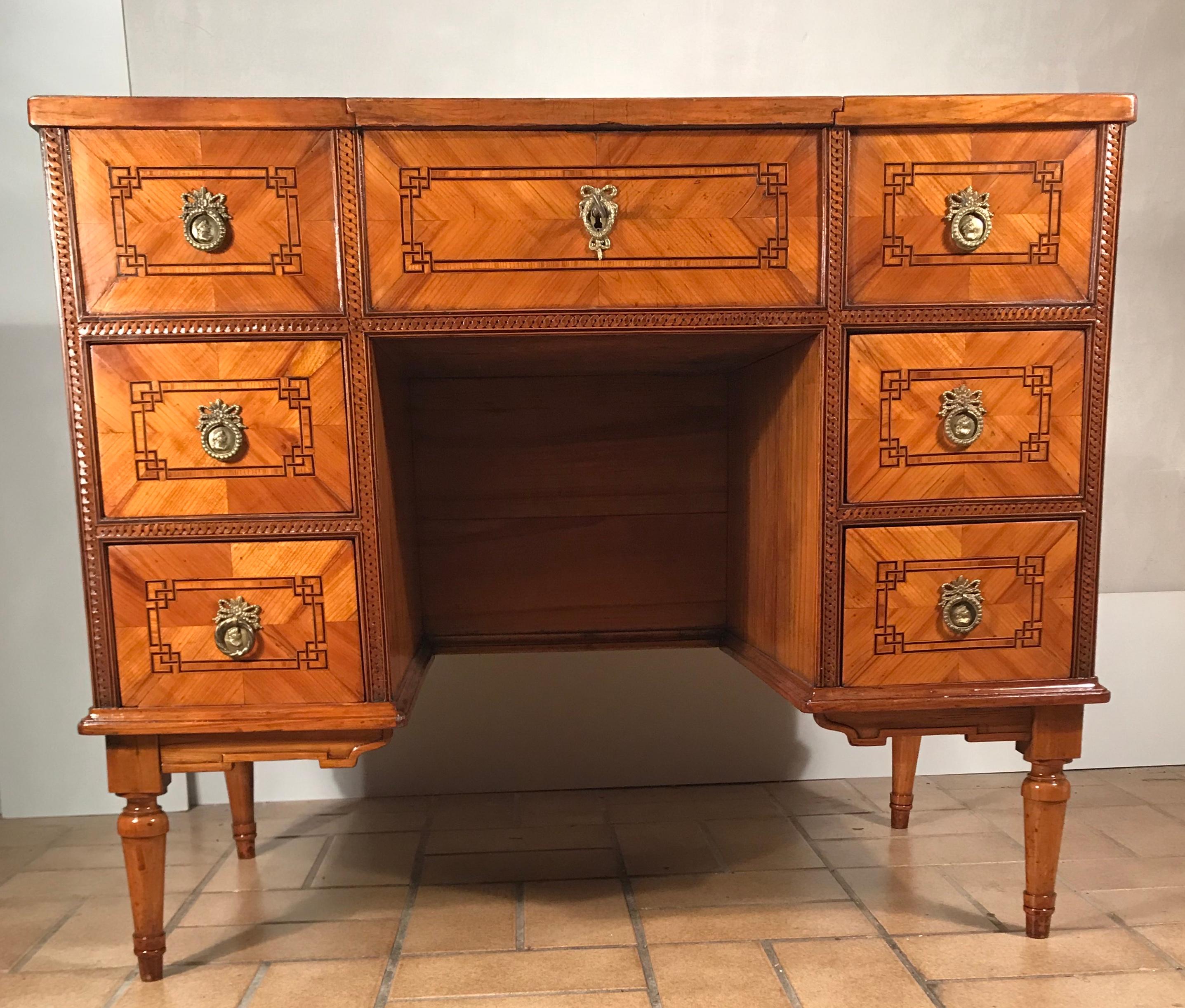 Exquisite Louis XVI dressing table, South East Germany, Würzburg region 1780. Cherry veneer with elm wood marquetry. The table has one central compartment with a flip up mirror and one additional compartment on each side. Furthermore, the front has