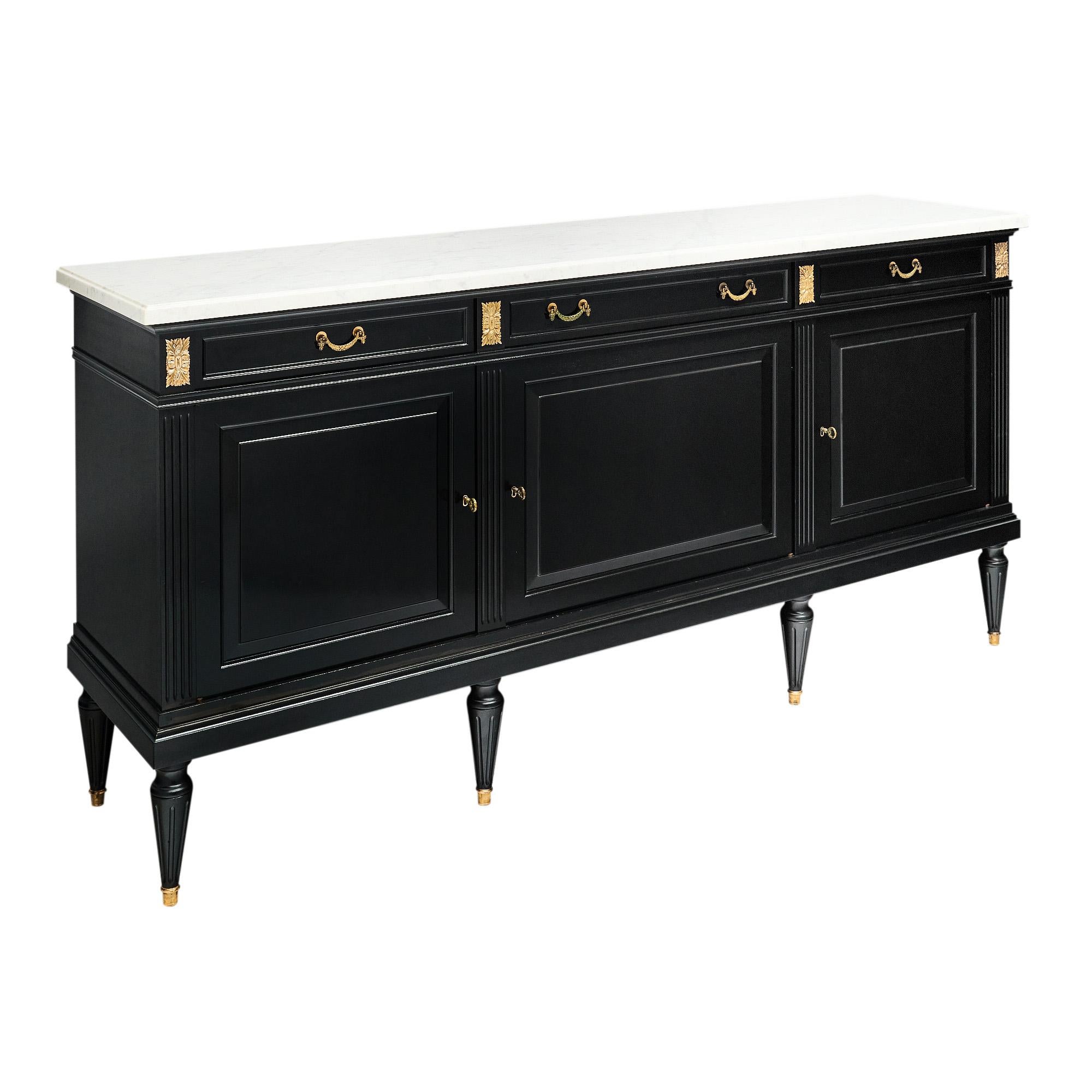 Buffet in the Louis XVI style from France. This piece is made of solid wood construction, primarily mahogany. It has been ebonized and finished with a lustrous French polish of museum quality. The three dovetailed drawers are all adorned with brass