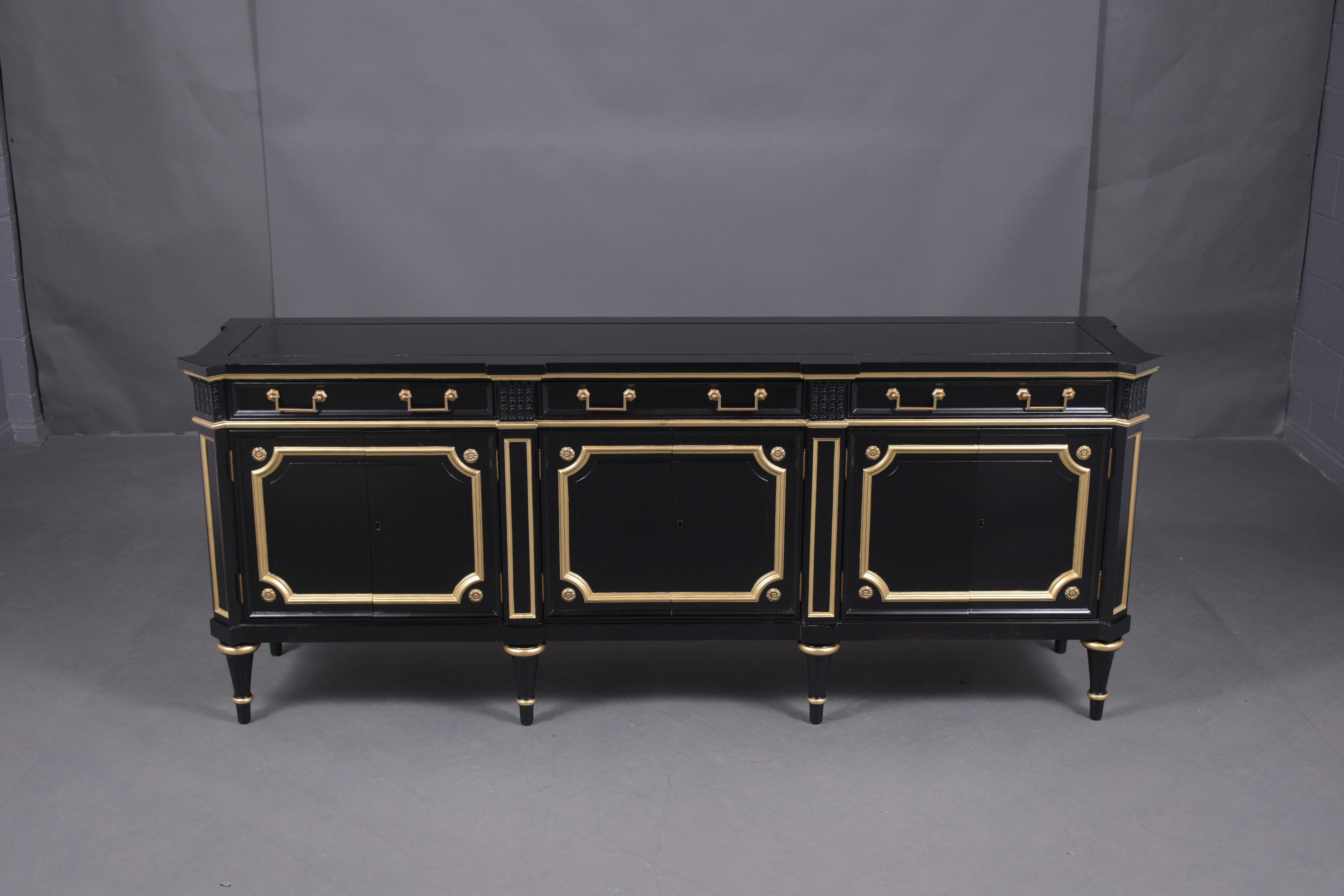 An extraordinary Louis xvi style enfilade buffet beautifully crafted out of mahogany wood in great condition professionally restored by our craftsmen team, this sideboard features an elegant ebonized color and gilt molding accents combination with