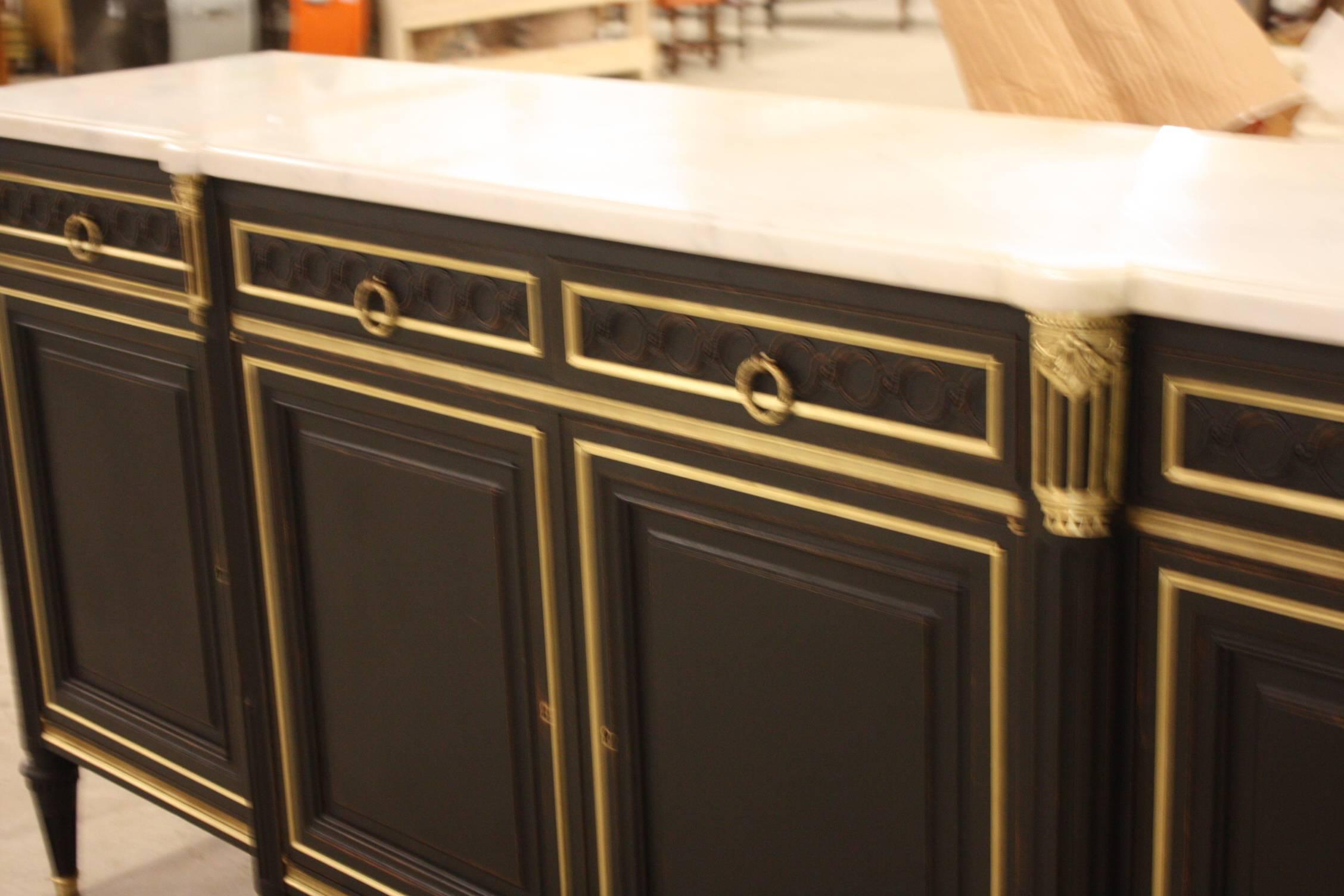 French Louis XVI buffet in a traditional ebonized finish with an exquisite white with gray veining marble top.