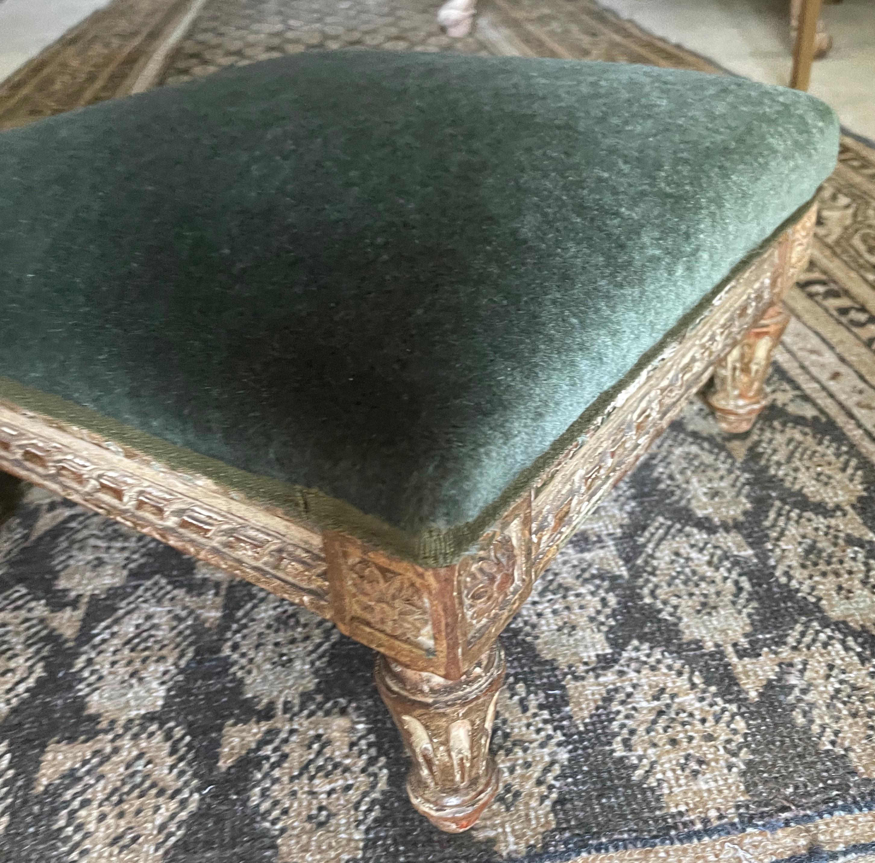Louis XVI green mohair footstool.  Antique French faded painted and gilt carved stool newly reupholstered in bottle green mohair. France late 18th early 19th century
Dimension: 14